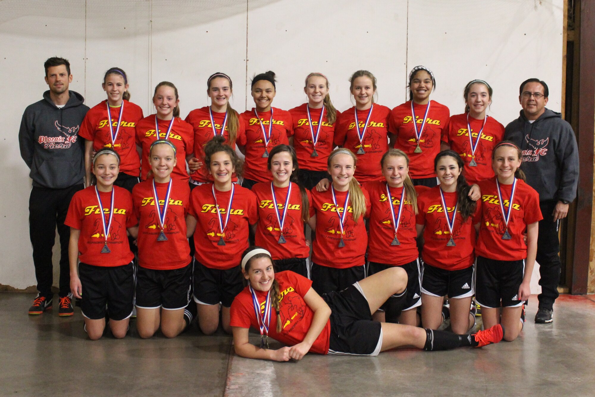 Retired U.S. Air Force Master Sgt. Richard Esparza, 55th Medical Group medical readiness manager, right, poses for a team photo with his under-15 girls premier team, Fiera, in 2013. The team received medals after winning their respective premier age division’s tournament. (U.S. Air Force courtesy photo)