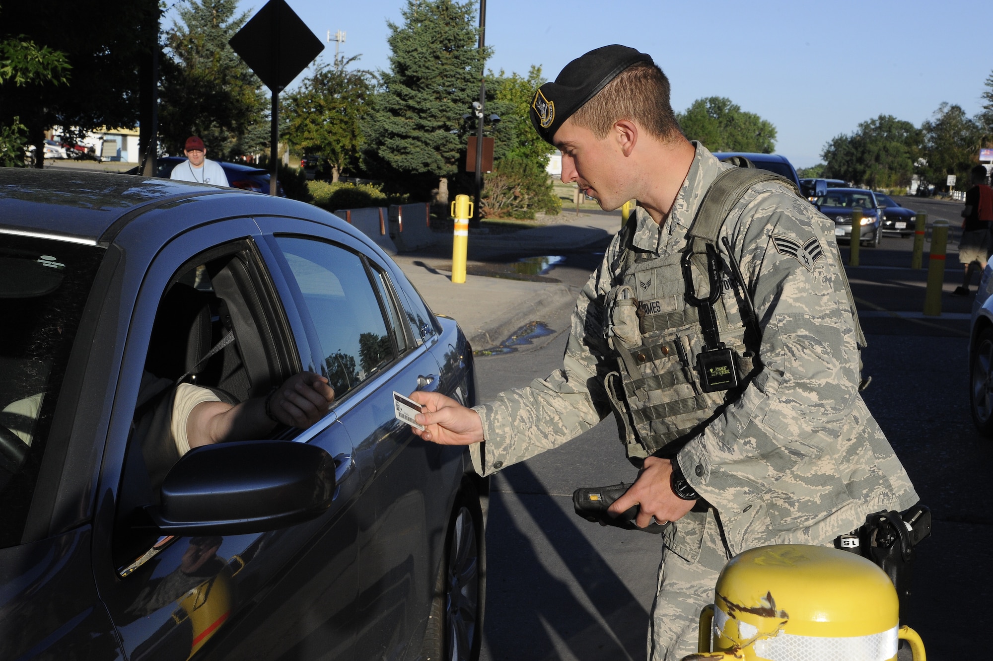 A Team Malmstrom member with the 341st Security Forces squadron uses a Defense Biometric Identification System scanner to verify a Department of Defense-issued ID card for someone requesting access to Malmstrom Air Force Base, Mont. Since Aug. 1, the DBIDS system now queries the FBI data base to check if there is an outstanding warrant on card holders. 
