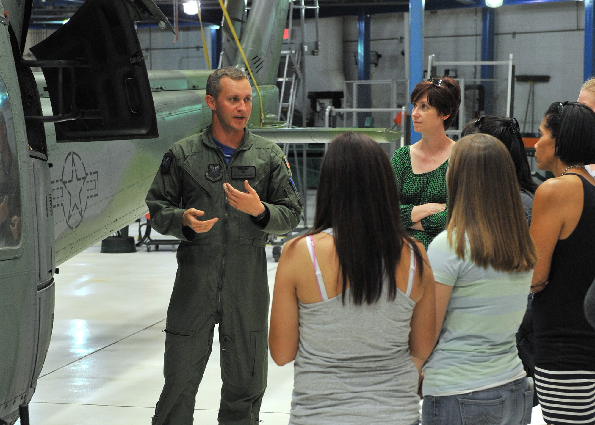 Staff Sgt. Robert Kohlenberg, 40th Helicopter Squadron special mission aviator, describes the capabilities of the squadron’s UH-1N helicopters Aug. 2 during a key spouse tour of Malmstrom Air Force Base, Mont. A similar tour, called ‘Mission Orientation,’ is given each month to Airmen who have just arrived to the installation and promotes understanding of the 341st Missile Wing’s mission. (Air Force photo/John Turner)
