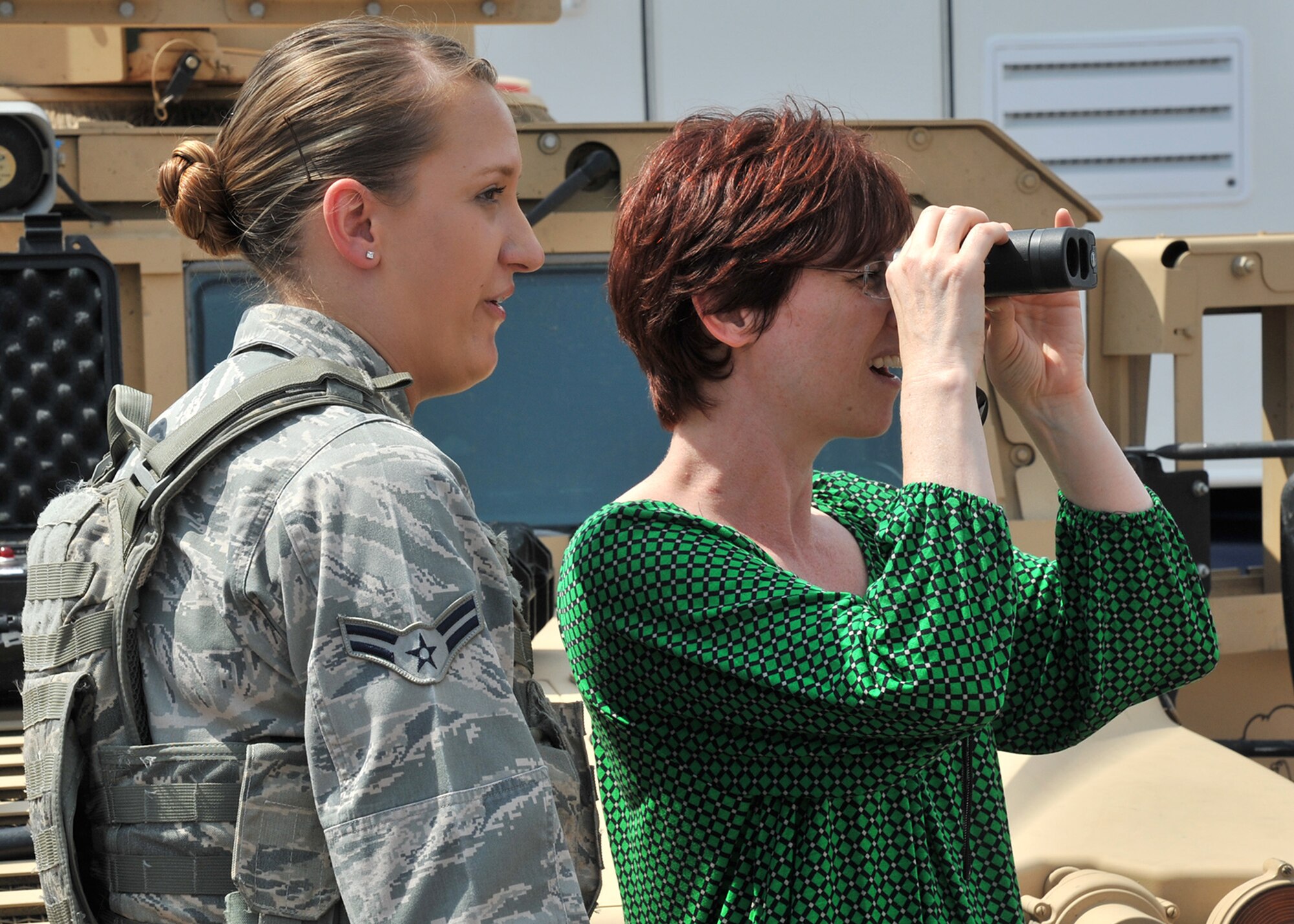 Airman 1st Class Brittany Meir, 741st Missile Security Forces Squadron member, watches as Suzanne Slaughter, 341st Munitions Squadron key spouse mentor, looks through a range finder Aug. 2 during a key spouse tour of Malmstrom Air Force Base, Mont. Base tours promote a better understanding of the 341st Missile Wing’s overall mission including how Airmen live and work in the missile complex. (Air Force photo/John Turner)