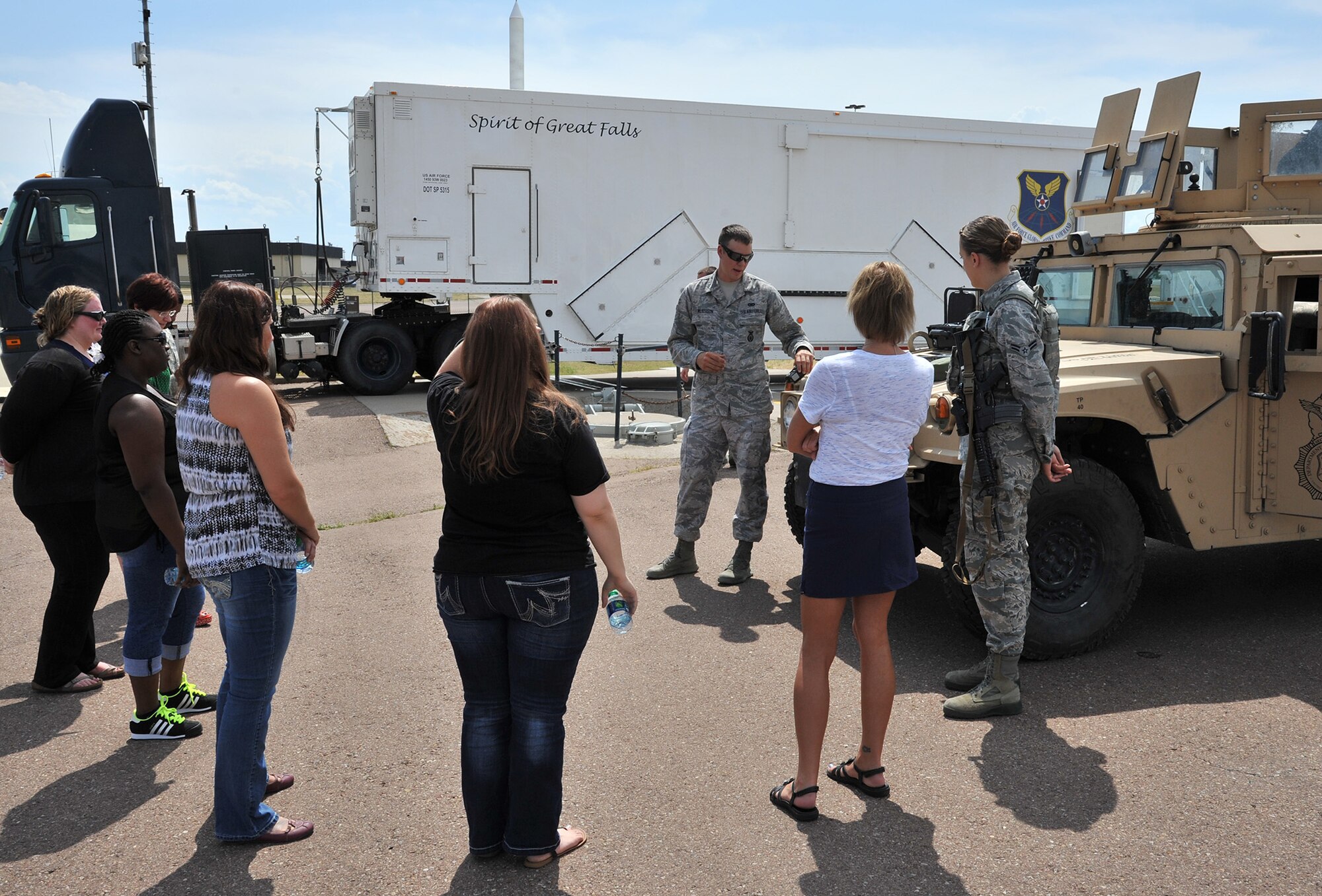 Airmen 1st Class Adam Wilkerson (center) and Brittany Meir (right), 741st Missile Security Forces Squadron members, demonstrate security forces vehicles and equipment Aug. 2 during a key spouse tour of Malmstrom Air Force Base, Mont. A similar tour, called ‘Mission Orientation,’ is given each month to Airmen who have just arrived to the installation and promotes understanding of the 341st Missile Wing’s mission. (Air Force photo/John Turner)