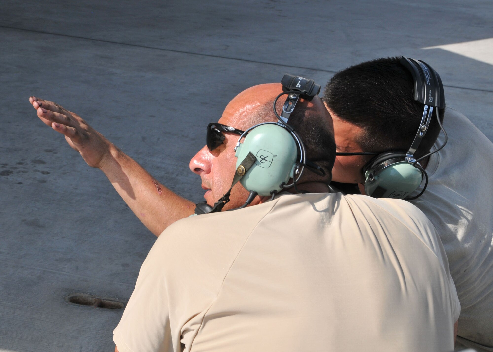 Air Force Airman 1st Class Spencer Watson explains his aircraft crew chief duties to Command Chief Master Sgt. Samer Alkhoury at the 380th Air Expeditionary Wing flightline June 21, 2014. (U.S. Air Force photo by Senior Master Sgt. Eric Peterson/Released)