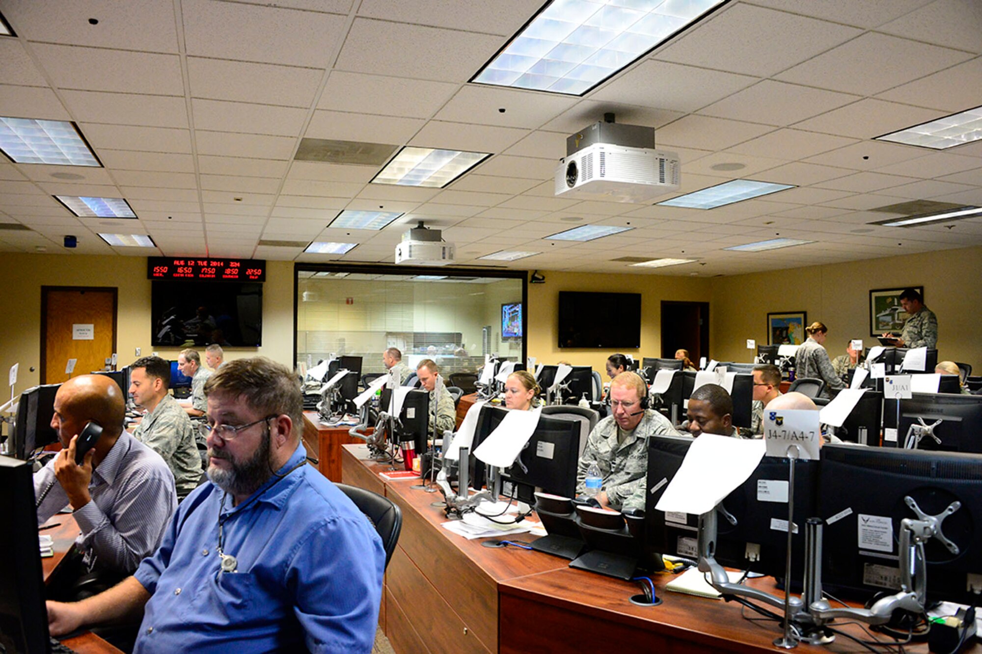 Members of 12th Air Force (Air Forces Southern) and the Air National Guard's 183rd Fighter Wing in Springfield, Ill. work side-by-side as part of the Crisis Action Team, during PANAMAX 2014, Davis-Monthan Air Force Base, Ariz., Aug. 12, 2014. The 183rd FW has been partnering with 12 AF (AFSOUTH) during PANAMAX for at least four years, bringing continuity and experience to the exercise. (U.S. Air Force photo by Tech. Sgt. Heather R. Redman/Released)
