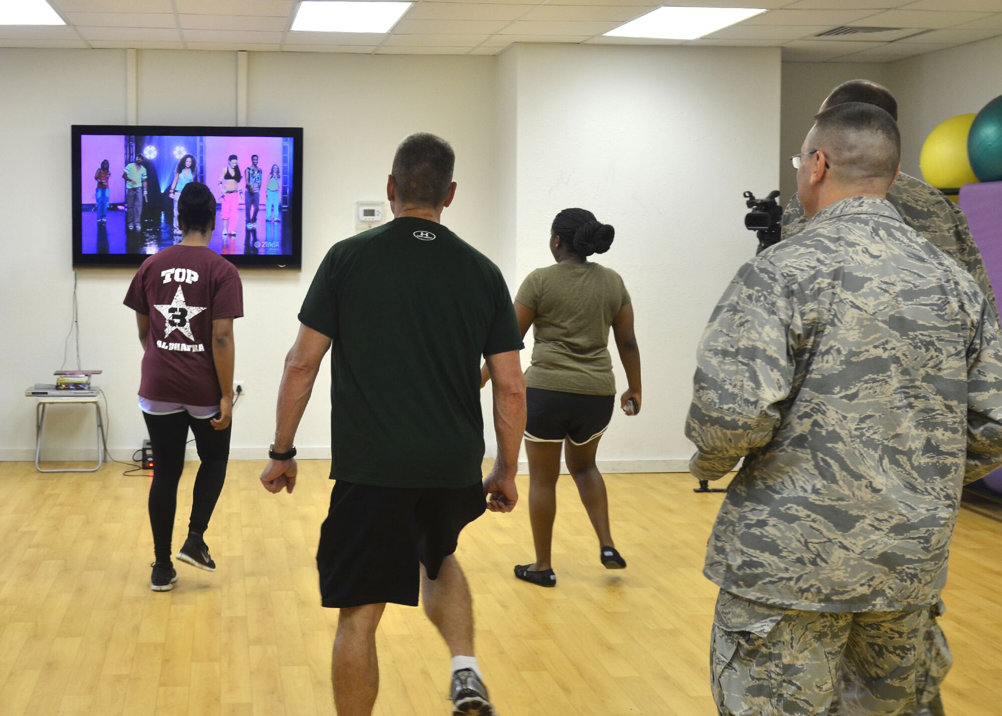 380th Air Expeditionary Wing Airmen were treated to a zumba demonstration during the new base fitness center grand opening in Southwest Asia Aug. 9, 2014. (U.S. Air Force photo by Maj. Jefferson S. Heiland) 