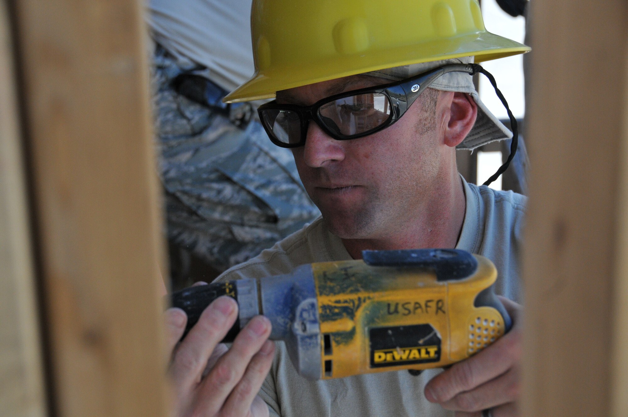 Tech. Sgt. Chris Panico, 512th Civil Engineer Squadron, drills nails into the framing of a module home being built in Gallup, N.M., July 23, 2014. The 512th CES built homes July 19 - Aug. 1 for a Navajo reservation in Gallup as part of the Department of Defense's Innovative Readiness Training program. The DoD IRT program provides service members with real world training while supporting the needs of underserved communities. (U.S. Air Force photo/Staff Sgt. Mercedes Crossland)
