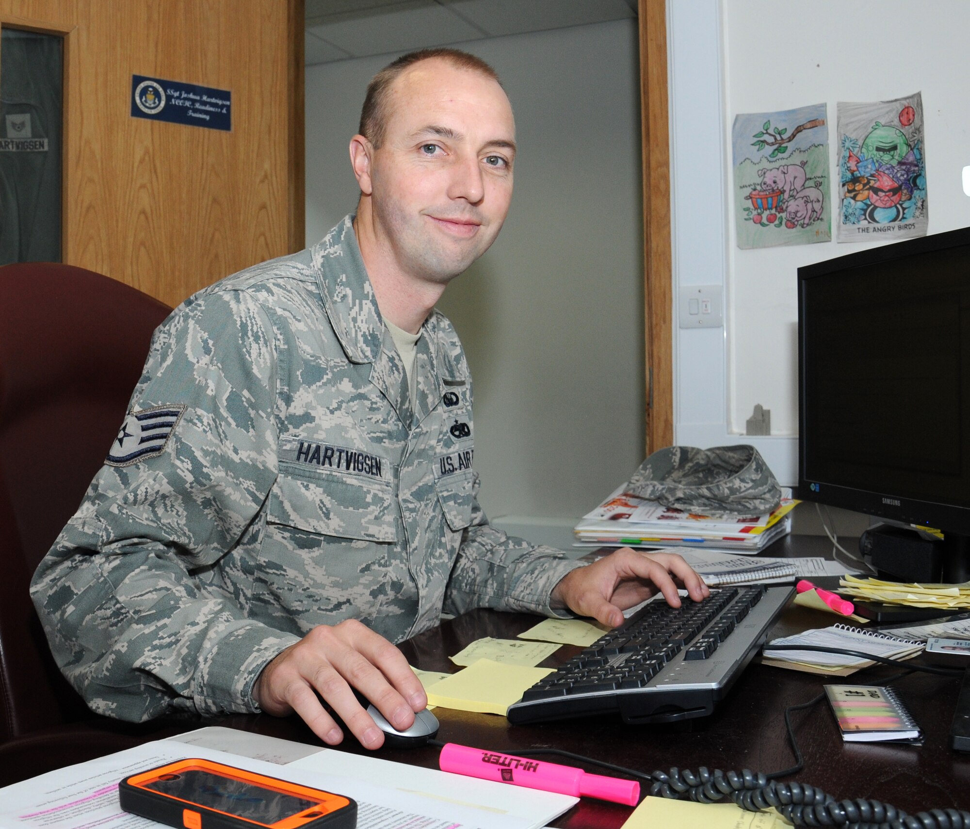 U.S. Air Force Staff Sgt. Joshua Hartvigsen, 100th Air Refueling Wing NCO in charge of chapel readiness and training from Bountiful, Utah, takes care of the logistics of the chapel Aug. 6, 2014, in the chapel on RAF Mildenhall, England. His role as a chaplain’s assistant is to take care of facilities, finances, and readiness and training of the chapel. (U.S. Air Force photo/Gina Randall/Released)