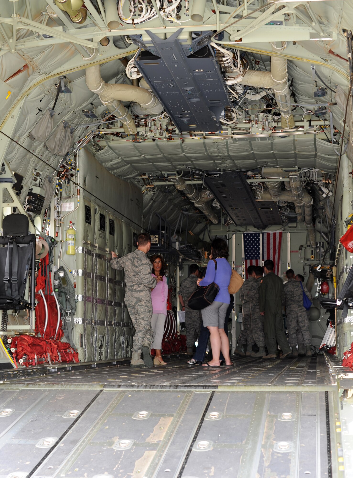 Spouses receive a brief while inside the cargo copmartment of the MC-130J Commando II during the Introduction to Special Operations Group Aug. 7, 2014, on RAF Mildenhall, England. The ISOG event is a class for those new to the 352nd Special Operations Group. Attendees were briefed by all different elements of the 352nd SOG as well as see several aerial platforms and ground equipment special operations forces use. (U.S. Air Force photo/Tech. Sgt. Stacia Zachary/Released)
