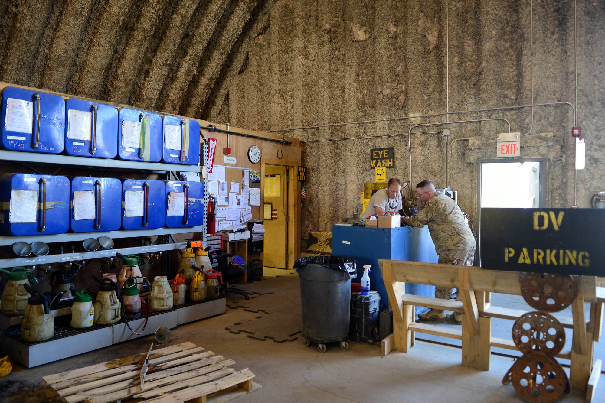 A U.S. Airman from the 455th Expeditionary Logisitics Readiness Squadron vehicle maintenance shop assists a customer at Bagram Airfield, Afghanistan Aug. 7, 2014.  Vehicle maintainers repair, inspect and maintain vehicles that are essential to the daily mission.  Their mission is to provide safe and serviceable vehicles such as Mine-Resistant Ambush Protection, refueling trucks, tractors, and construction equipment. (U.S. Air Force photo by Staff Sgt. Evelyn Chavez/Released)