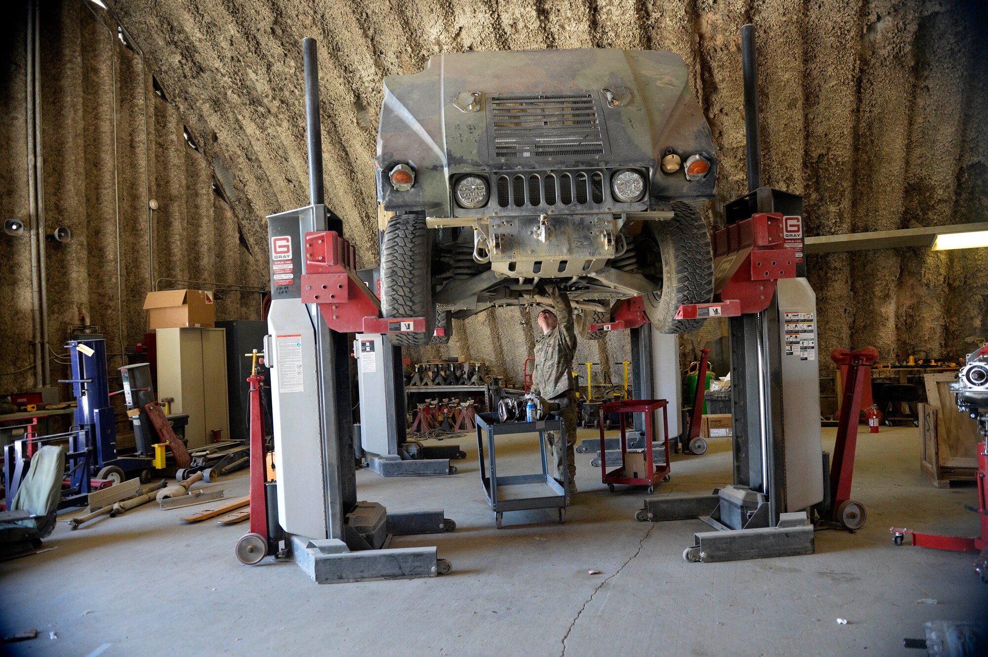 U.S. Air Force Senior Airman Christopher Horton, 455th Expeditionary Logistics Readiness Squadron vehicle maintenance equipment mechanic, inspects a HMMWV for transmission replacement at Bagram Airfield, Afghanistan Aug. 7, 2014.  As part of vehicle maintenance, Horton is responsible for repairing an average of 200 vehicles per month.  The shop maintains general and special purpose vehicles such as cars, tractors and forklifts.  Horton is deployed from the Tennessee Air National Guard and a native of Memphis, Tenn. (U.S. Air Force photo by Staff Sgt. Evelyn Chavez/Released)