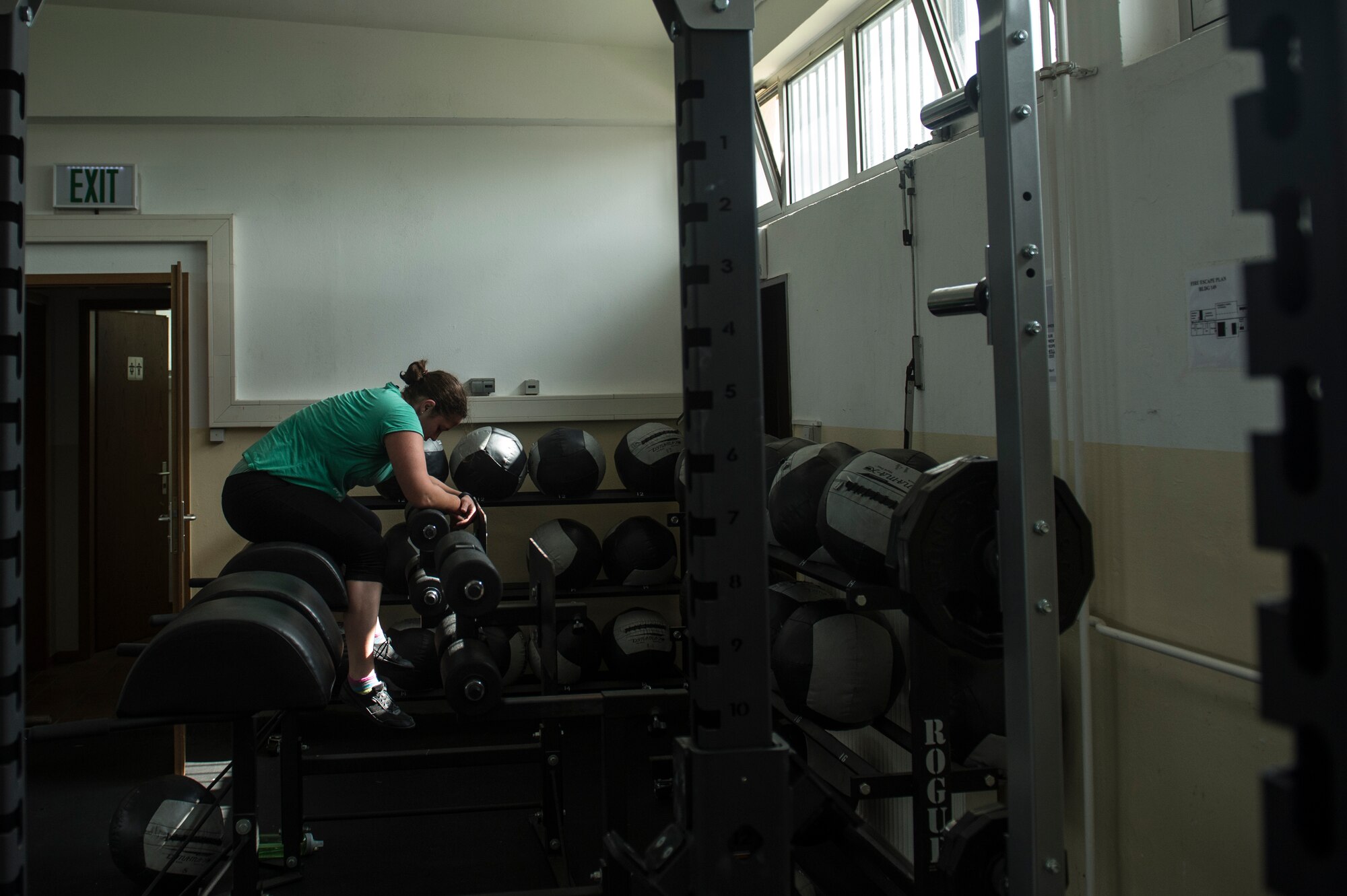 U.S. Air Force Staff Sgt. India Smith, 372nd Training Squadron Detachment 17 NCO in charge of knowledge operations from Ottawa, Kan., rests during a workout Aug. 11, 2014, at Spangdahlem Air Base, Germany. By performing combat fitness exercises, Smith is two dress sizes away from accomplishing one of her goals. (U.S. Air Force photo by Senior Airman Rusty Frank/Released)