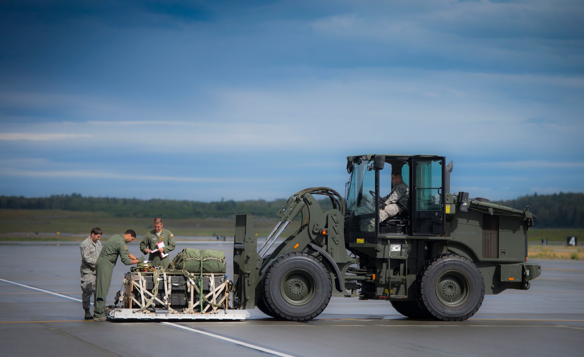Loadmasters from the 36th Airlift Squadron work with riggers from the 374th Logistics Readiness Squadron prior to loading cargo on to a C-130 Hercules during Exercise RED FLAG-Alaska on Aug. 13, 2014, Joint Base Elmendorf-Richardson, Alaska. RED FLAG provides joint offensive counter-air, interdiction, close air support, and large force employment training in a simulated combat environment. (U.S. Air Force photo by Staff Sgt. Chad C. Strohmeyer/Released)