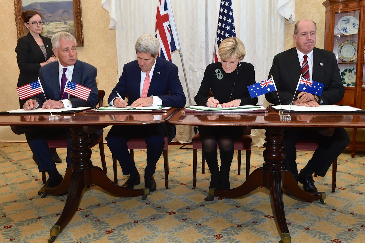 U.S. Secretary of State John F. Kerry, center left, and Australian Foreign Minister Julie Bishop, center right, flanked by U.S. Defense Secretary Chuck Hagel, left, and Australian Defense Minister David Johnston, right, sign a force posture agreement during bilateral defense and diplomatic meetings in Sydney, Aug. 12, 2014. State Department photo