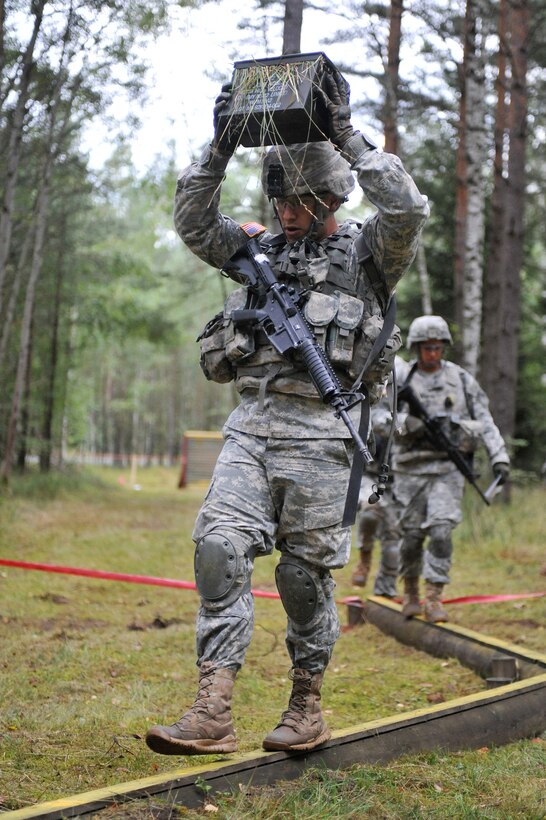 U.S. Army Sgt. Timothy Jenkins maintains his balance as he traverses an obstacle during the Joint Multinational Training Command's Best Warrior Competition on Grafenwoehr Training Area, Germany, Aug. 12, 2014. Jenkins is assigned to Company A, 1st Battalion, 4th Infantry Regiment. 