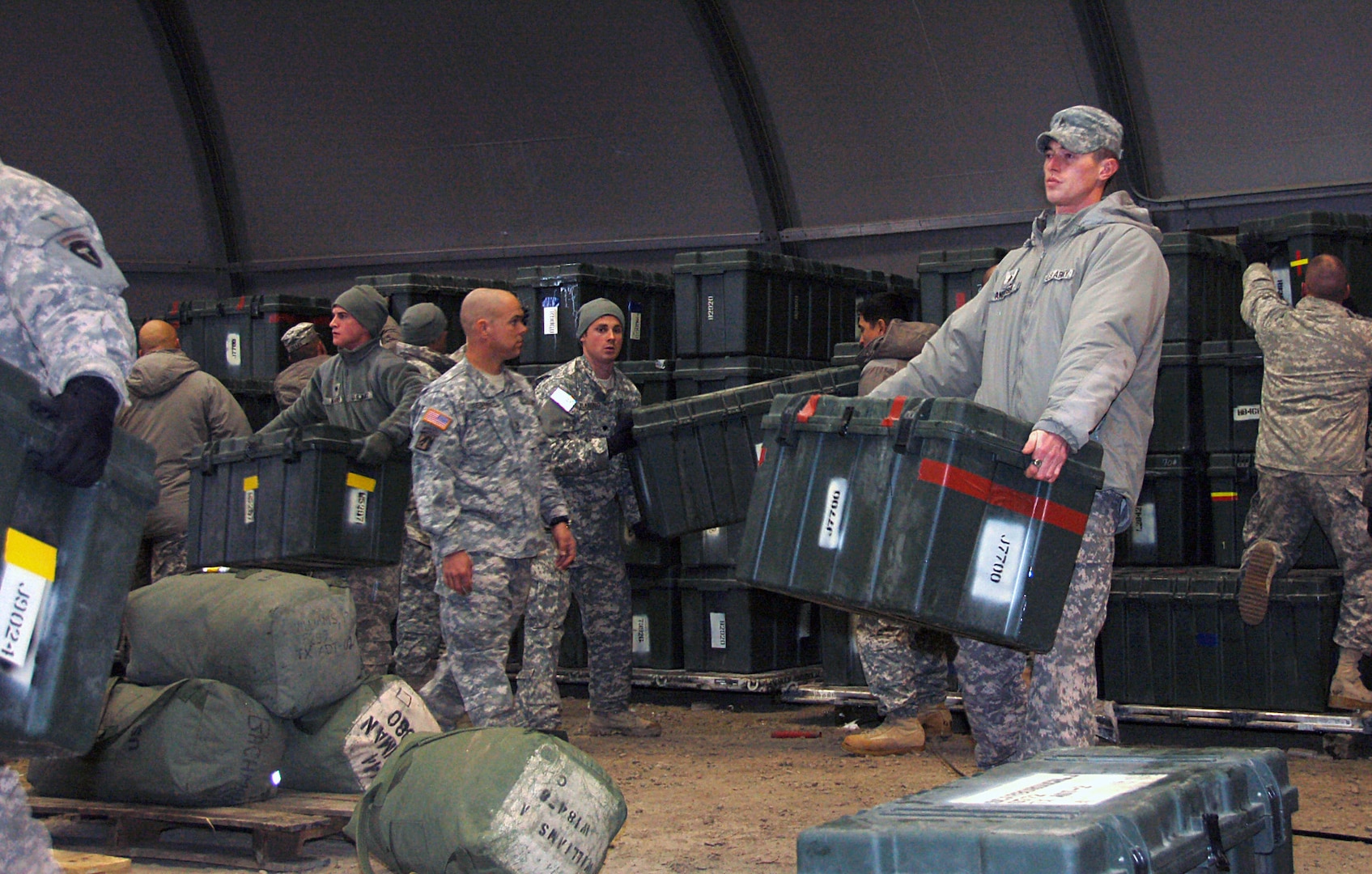 Soldiers from the Texas Agribusiness Development Team unload and separate their supplies in the shipment yard at Camp Atterbury Joint Maneuver Training Center Dec. 28, 2009, before they leave for home. The Texas ADT arrived at Camp Atterbury on Christmas Day for demobilization processing after a year-long deployment in Afghanistan.