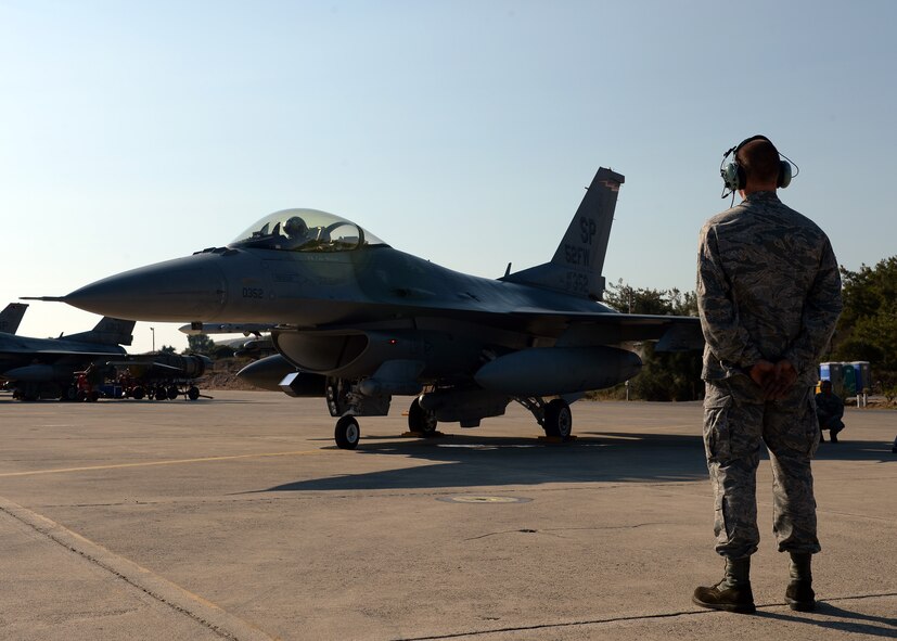 Senior Airman Alan Nelson watches an F-16 Fighting Falcon prepare for takeoff Aug. 12, 2014, during a bilateral training event in Souda Bay, Greece. The U.S. and Hellenic air forces prepare more than 20 aircraft launches a day for during the two-week bilateral training event. Nelson is with the 480th Aircraft Maintenance Unit, Spangdahlem Air Base, Germany, and is a native of Pensacola, Fla. (U.S. Air Force photo/Staff Sgt. Daryl Knee)