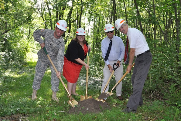 Ground was broken on the Canadaway Creek Sewer Line Protection Project, Dunkirk, NY, August 12, 2014. (Left to Right: U.S. Army Corps of Engineers, Buffalo District Commander LTC Karl Jansen,Congressmen Reed's representative Jacquelyn Chiarot, Village of Fredonia Mayor Steve Keefe, and State Assemblyman Andrew Goodell) 

The contract, awarded to Strock Enterprises LTD, is for construction of a trench-fill revetment, along approximately 800 feet of the creek’s left bank, parallel to the main sewer line. The revetment is constructed by first digging a ditch along the creek, filling it with a combination of steel mesh and rip rap, and then back filling and covering the ditch. As the shore erodes with time, the rip rap with fall into place and create a natural protected creek bank. 