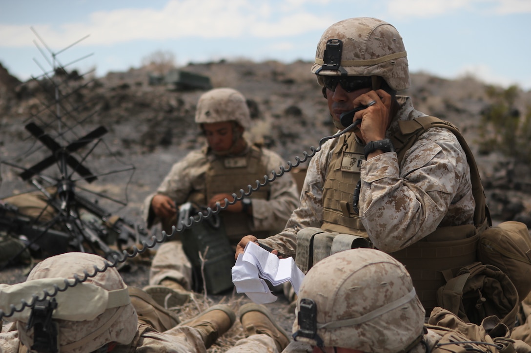 Captain Javier Gonzalez, an infantry officer with Company F, 2nd Battalion, 7th Marine Regiment, conducts a radio operations check for a fire support operation during Large Scale Exercise 2014 aboard Marine Corps Air Ground Combat Center Twentynine Palms, Calif., Aug. 9-10, 2014. Fire support drills are conducted by a fire team that calls for attacks on distant targets through the use of air support, mortars and artillery. LSE-14 is a bilateral training exercise being conducted by 1st Marine Expeditionary Brigade to build U.S. and Canadian forces’ joint capabilities through live, simulated, and constructive military training activities. (U.S. Marine Corps photo by Lance Cpl. Angel Serna/Released)