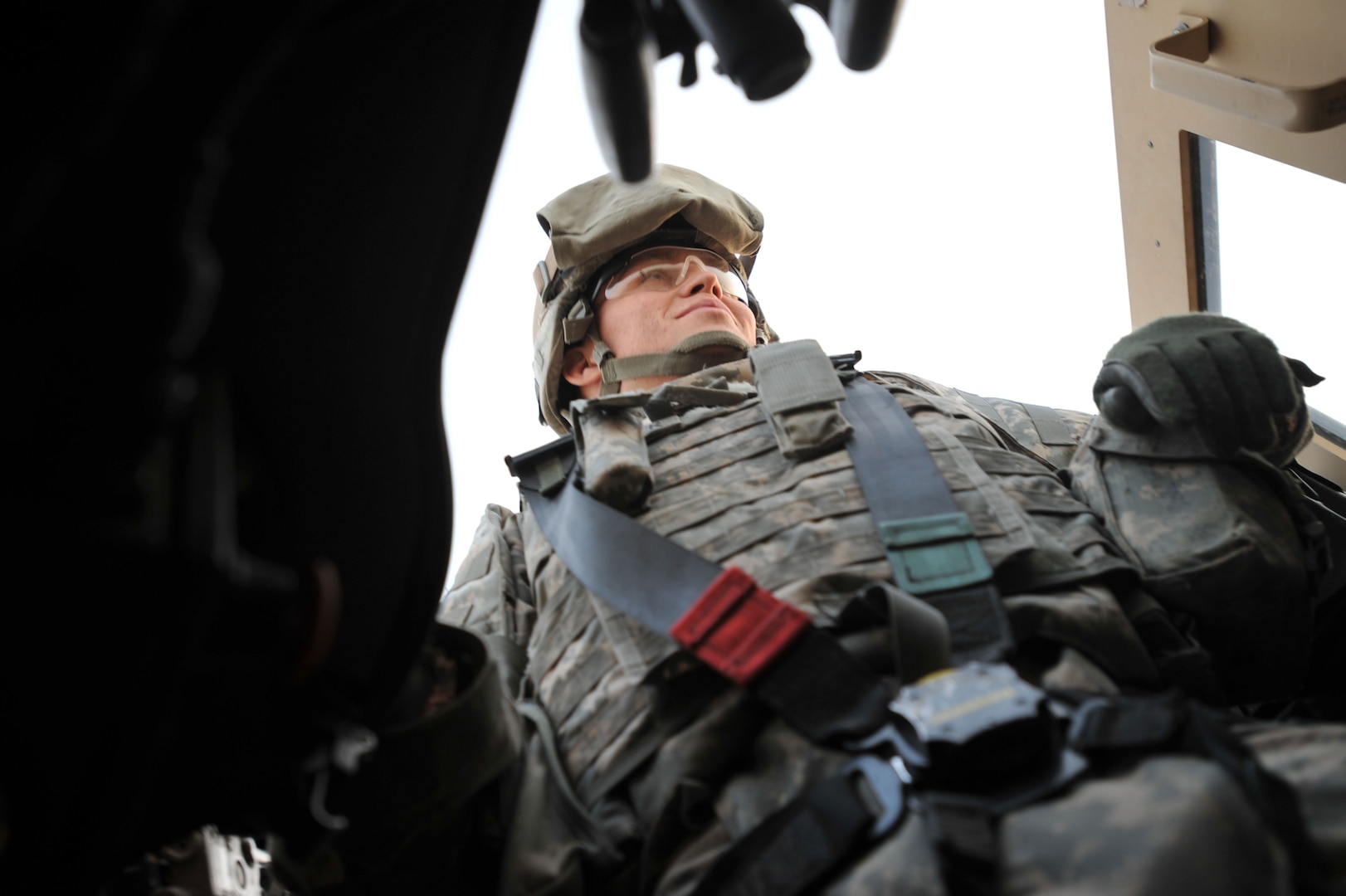 Spc. Andrew Alexander of the Wisconsin National Guard scans the roads from the gunner's turret of a Mine-Resistant Ambush-Protected vehicle.