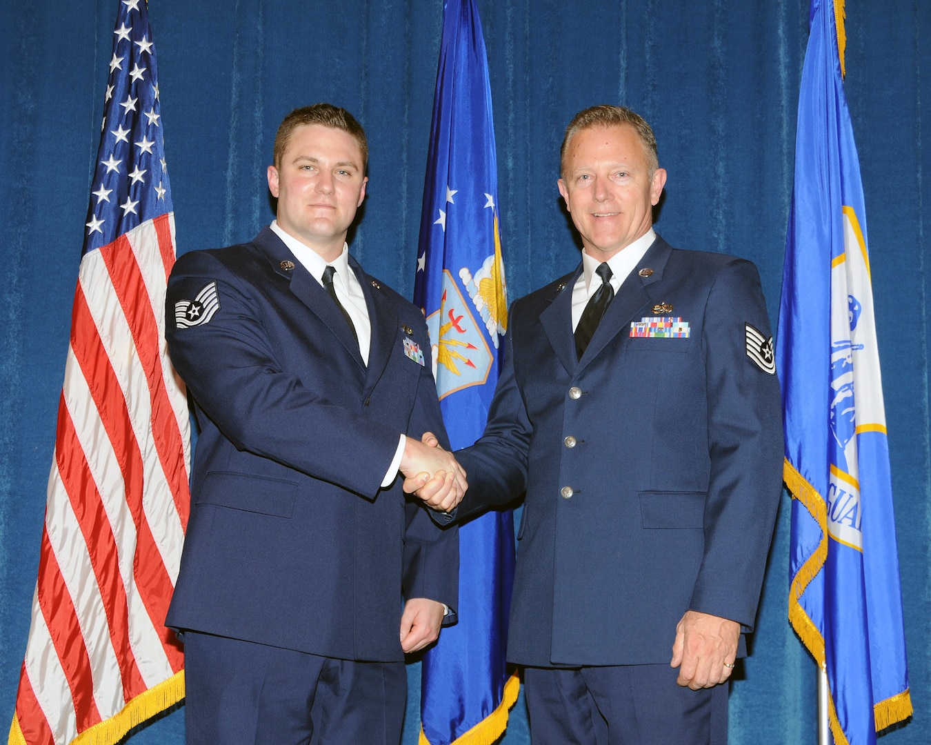 Tech. Sgt. Adam C. Helligrass, left, and his father, Tech. Sgt Robert J. Helligrass, both aerospace maintenance craftsmen with the 109th Airlift Wing in Scotia, N.Y., graduate together from the Satellite Noncommissioned Officer (NCO) Academy Class 10-2 at The I.G. Brown Air National Guard Training and Education Center, Dec. 15, 2009.