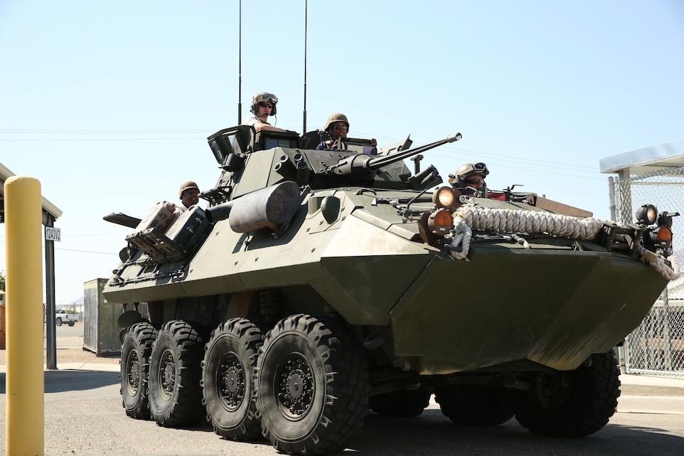Professors with the Defense Science Study Group ride in a light armored Vehicle with Marines with 3rd Light Armored Reconnaissance Battalion during a tour of the Combat Center, Aug. 5, 2014.