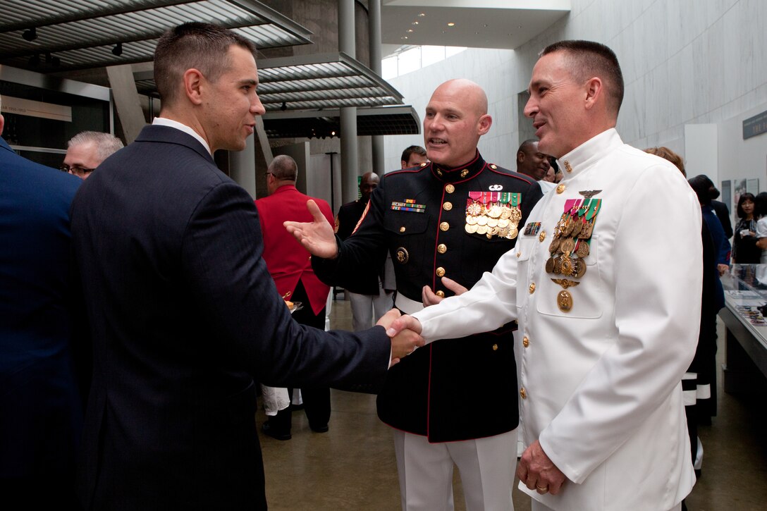 Master Chief Petty Officer Michael D. Stevens, the 13th Master Chief Petty Officer of the Navy, greets guests at the Sunset Parade reception at the Women in Military Service For America Memorial in Arlington, Va., on Aug. 12, 2014. (U.S Marine Corps photo by Lance Cpl. Jacob R. Bozic/ Released)