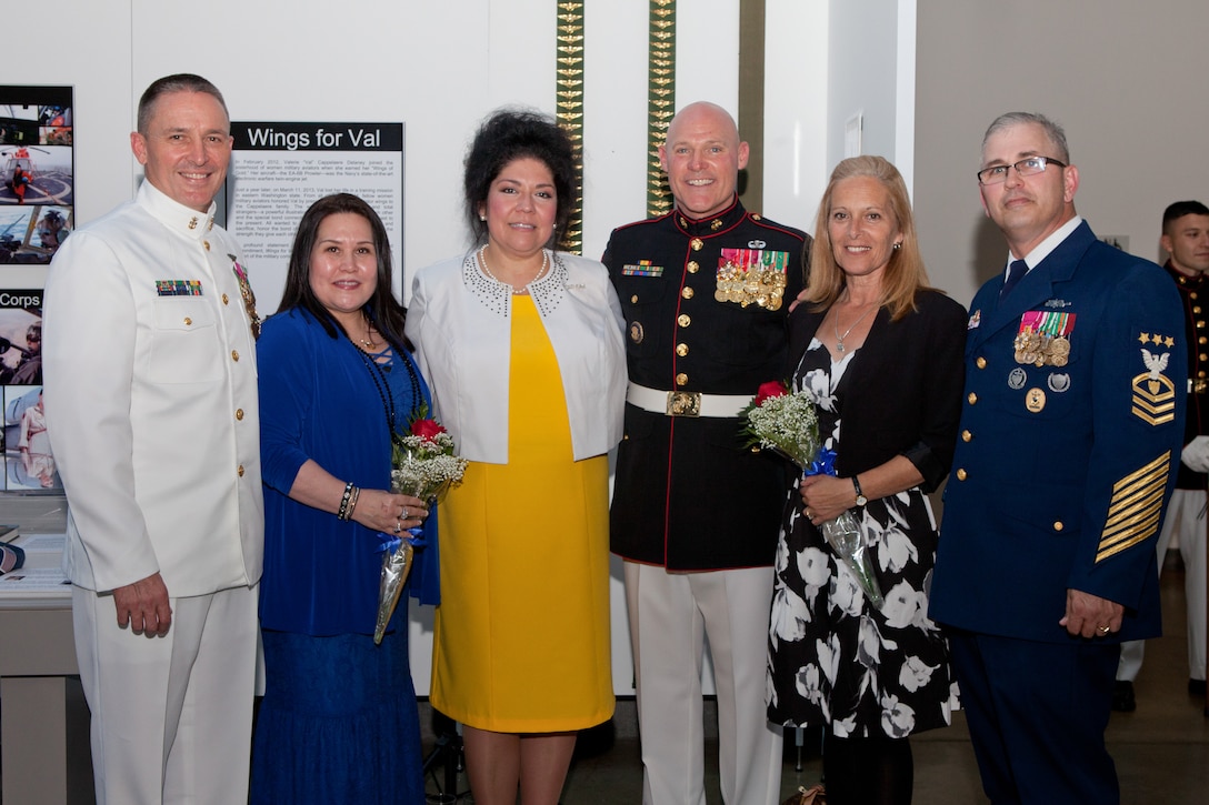 Sgt. Maj. Micheal P. Barrett, the 17th Sergeant Major of the Marine Corps, stands with Master Chief Petty Officer Michael D. Stevens, the 13th Master Chief Petty Officer of the Navy, his wife Theresa Stevens (left), and Master Chief Petty Officer Steven W. Cantrell, the 12th Master Chief Petty Officer of the Coast Guard, and his wife Janet Cantrell (right), during the Sunset Parade reception at the Women in Military Service For America Memorial in Arlington, Va., on Aug. 12, 2014. (U.S Marine Corps photo by Lance Cpl. Jacob R. Bozic/ Released)