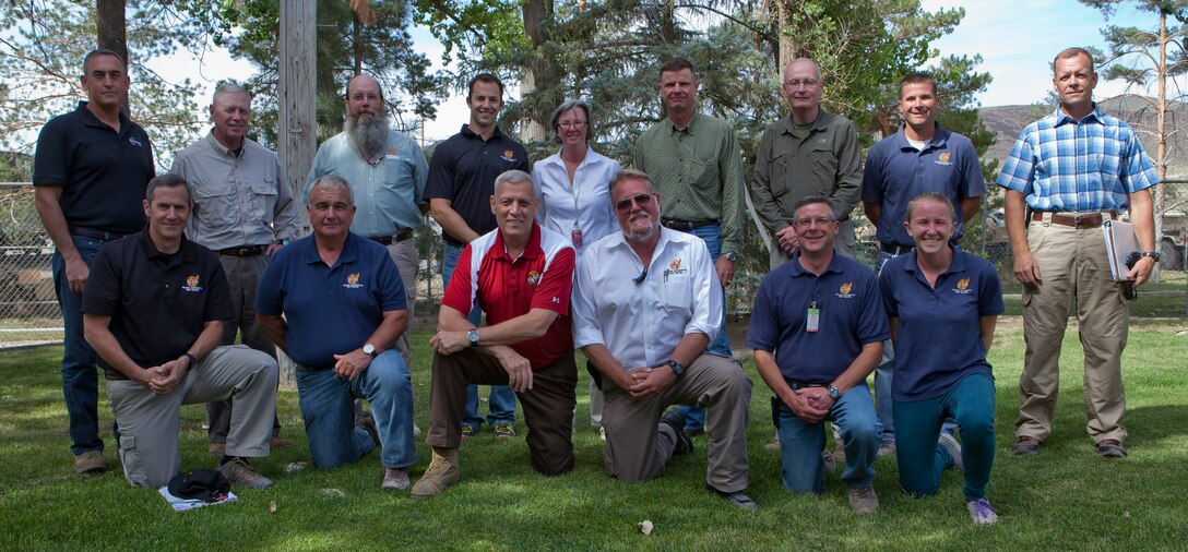 The Assistant Commandant of the Marine Corps, Gen. John M. Paxton, Jr., poses for a photo with employees at the Nevada Automotive Test Center, Silver Springs, Nv., Aug. 12, 2014. (U.S. Marine Corps photo by Cpl. Tia Dufour/Released)