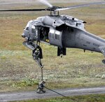 Pararescuemen Staff Sgt. Jeremy Madama, on ground, and Master Sgt. Johhny Davis deploy from a 210th Rescue Squadron HH-60 Pave Hawk via fast rope. Both are members of the Alaska National Guard, which saved 48 lives in Alaska in 2009 and assisted 12 others to safety during another busy year.