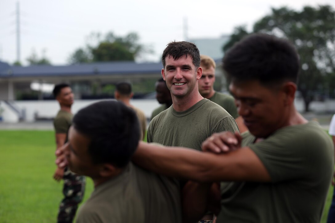 U.S. Marine Corps Sgt. Joshua McFarland with 3rd Law Enforcement Battalion, III Marine Headquarters Group observes service members from the Armed Forces of the Philippines and Philippine National Police practicing mechanical advantage control hold techniques at Fort Bonifacio, Philippines on Aug. 04, 2014 during the Non-Lethal Weapons Executive Seminar field training exercise. The effective use of non-lethal weapons can be extremely valuable during rescue missions, for force protection in civil disturbances, while controlling rioting and prisoners of war, for checkpoint or convoy operations, HA/DR operations, or in situations in which civilians are used to mask a military attack. 