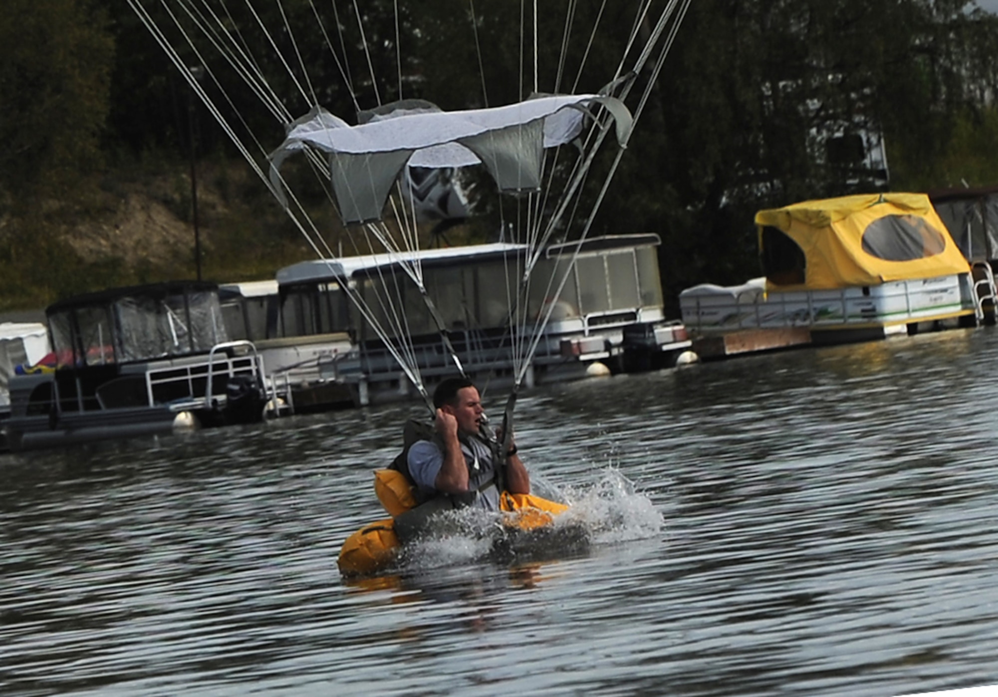 A paratrooper assigned to the 4th Infantry Brigade Combat Team (Airborne), 25th Infantry Division, U.S. Army Alaska, makes a water landing in Big Lake, Alaska, Wednesday, Aug. 6, 2014, with T-11 parachutes. This training event prepares the brigade's troopers for potential water landings, and highlights the unit's ability to perform airborne operations under challenging conditions and locations anywhere in the world. (U.S. Air Force photo/Justin Connaher)