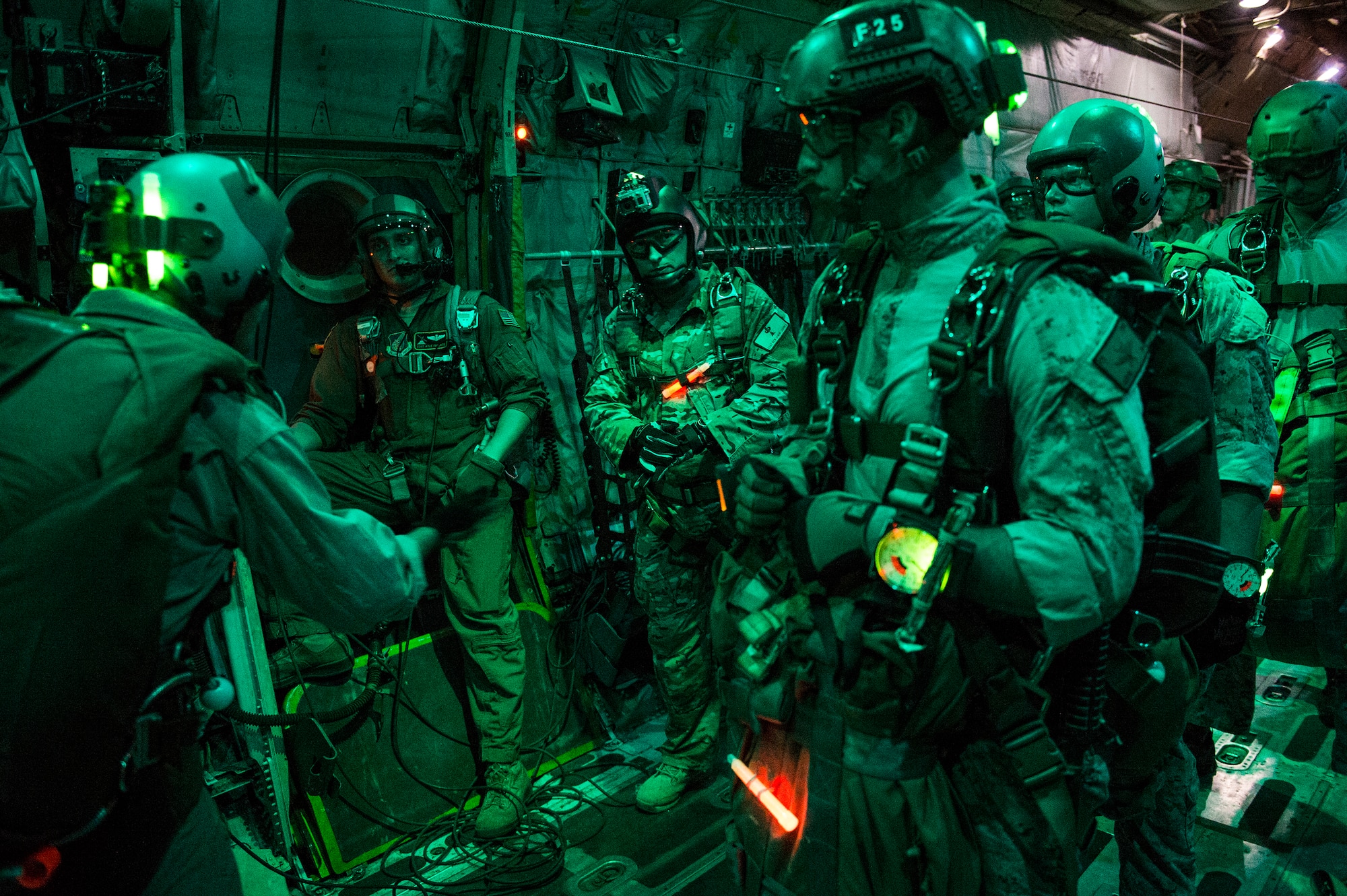 U.S. Marine Corps Gunnery Sgt. Kenny Bateman, 31st Marine Expeditionary Unit jump master, gives time signals to the crew after checking the ramp during a personnel-drop mission out of a C-130H Hercules aircraft from the 36th Airlift Squadron, Yokota Air Base, Japan, Aug. 11, 2014. The 36th AS conducts theater airlift, special operations, aeromedical evacuation, search and rescue, repatriation and humanitarian relief missions with a C-130H Hercules mission-ready aircrew while being the only forward-based tactical airlift squadron in the Pacific. (U.S. Air Force photo by Staff Sgt. Stephany Richards/ Released)