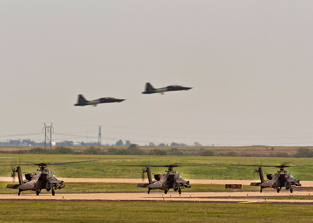 Three U.S. Army, AH 64 Delta Apache helicopters depart after a fuel stop enroute to Fort Carson, Colo., on Aug. 14, 2014 Sheppard Air Force Base, Texas. Sheppard is an enroute stop off to get fuel for military aircraft heading to another location. (U.S. Air Force photo by Danny Webb/Released) 
