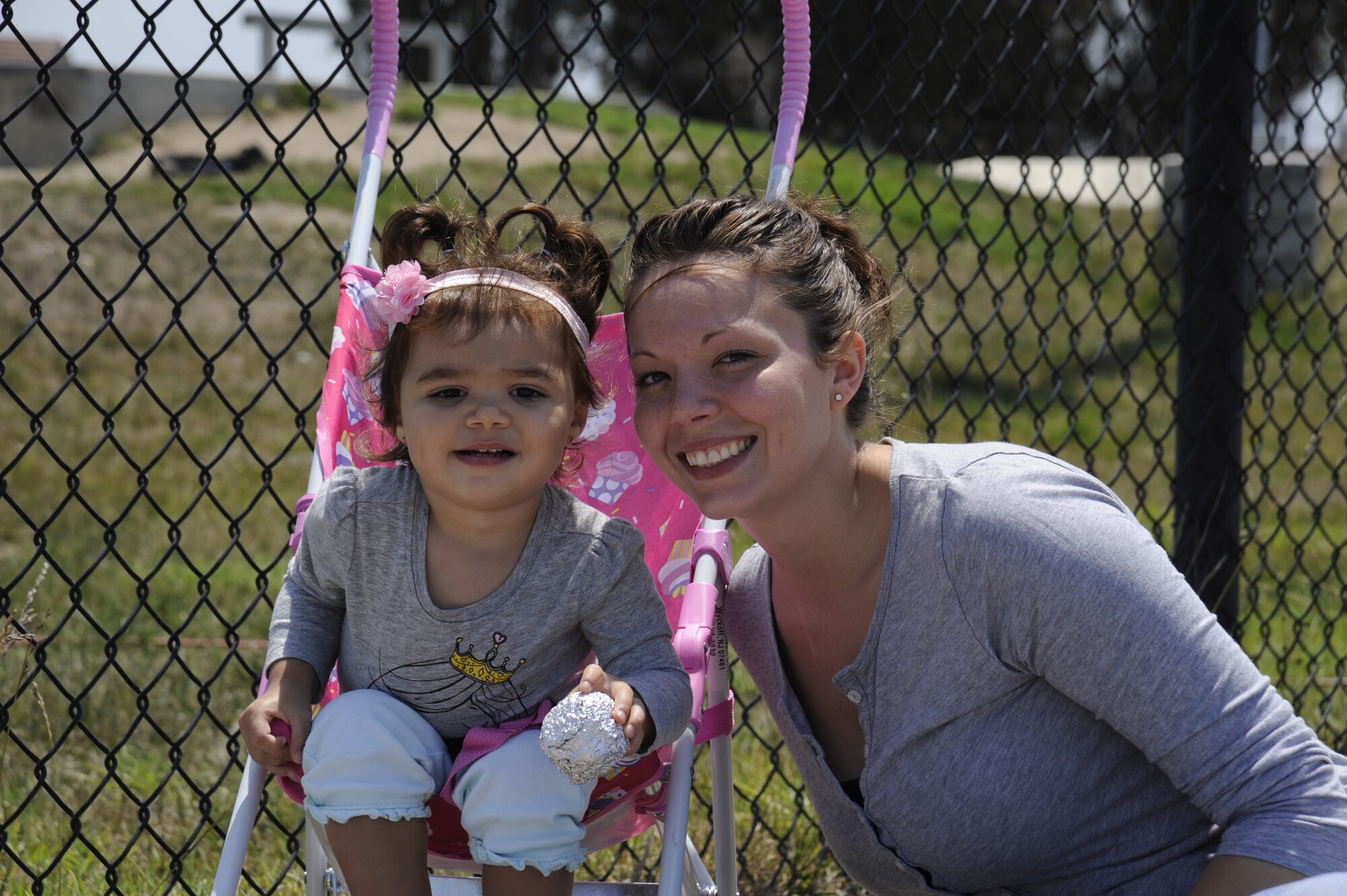Staff Sgt. Amber Rembert, 30th Civil Engineer Squadron dorm leader and her daughter Kiya, spend time together after lunch at the Salute to Youth event, Vandenberg Air Force Base, Aug. 8, 2014. Salute to Youth began as a way for base affiliated families, with an emphasis on those with special needs, to become familiar with local education opportunities for their children. (U.S. Air Force photo by Airman 1st Class Ian Dudley/Released)