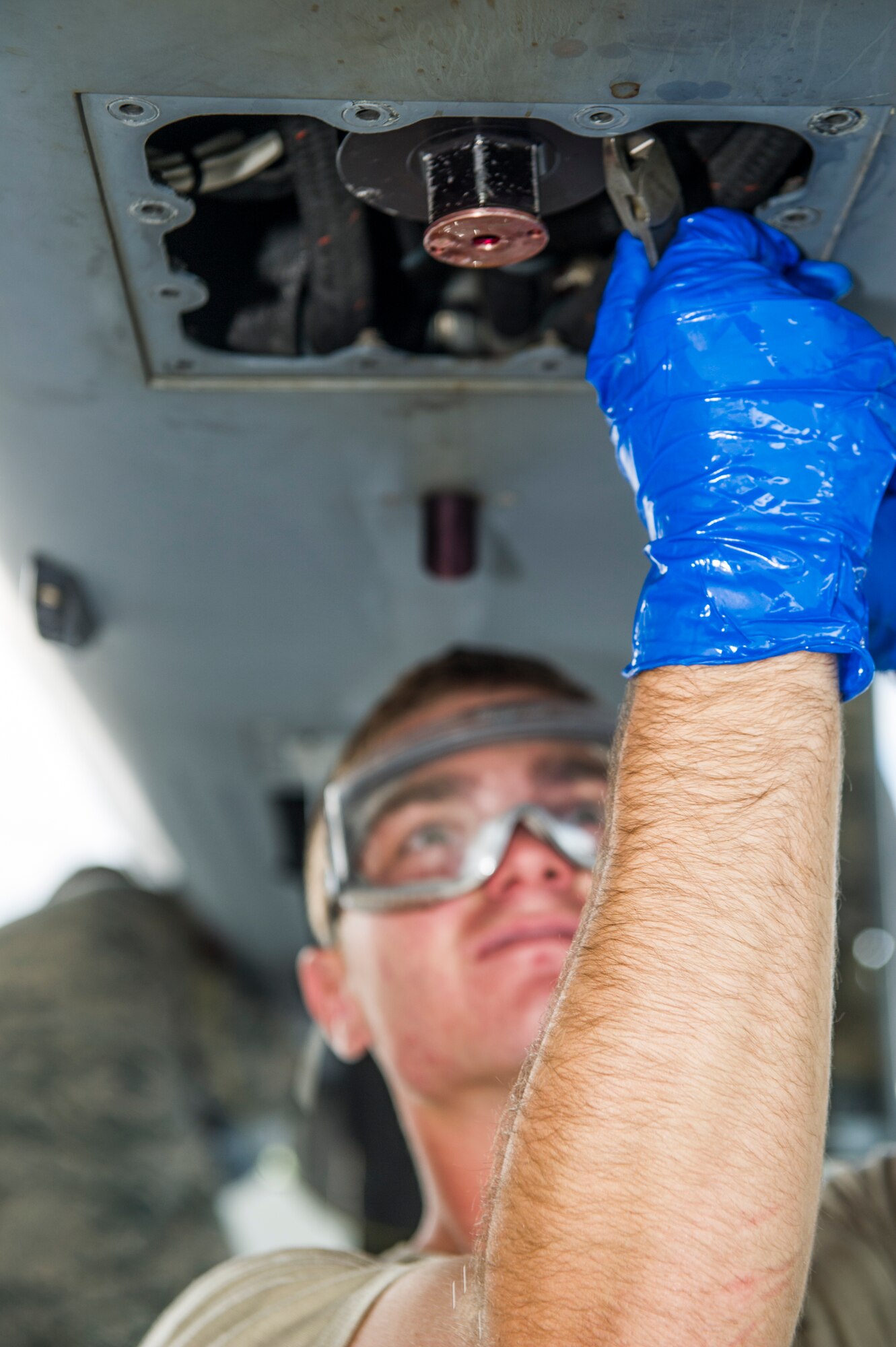 A1C Jordan Pool, 49th Aircraft Maintenance Squadron MQ-9 Reaper crew chief, performs a routine inspection on an MQ-9 remotely piloted aircraft at Holloman Air Force Base, N.M., Aug. 12. The 49th AMXS thoroughly inspects each part of the aircraft before takeoff and after landing, looking for any discrepancies that could interfere with the proper operation of the aircraft. Inspections are performed based on various factors including total hours flown and discrepancies noticed or reported during training sorties. Additional inspections are completed on several milestones including 200, 400, 800 and 2,000 hours of flight time. Each inspection is more in-depth as the flight hours increase.  (U.S. Air Force photo by Airman 1st Class Aaron Montoya / Released)