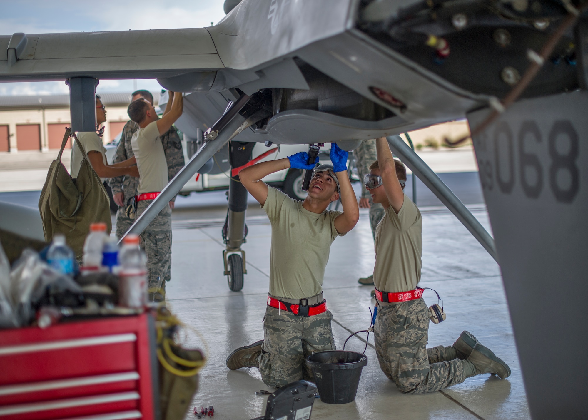 MQ-9 Reaper crew chiefs from the 49th Aircraft Maintenance Squadron perform a routine inspection on an MQ-9 remotely piloted aircraft at Holloman Air Force Base, N.M., Aug. 12. The 49th AMXS thoroughly inspects each part of the aircraft before takeoff and after landing, looking for any discrepancies that could interfere with the proper operation of the aircraft. Inspections are performed based on various factors including total hours flown and discrepancies noticed or reported during training sorties. Additional inspections are completed on several milestones including 200, 400, 800 and 2,000 hours of flight time. Each inspection is more in-depth as the flight hours increase. (U.S. Air Force photo by Airman 1st Class Leah Ferrante / Released)
