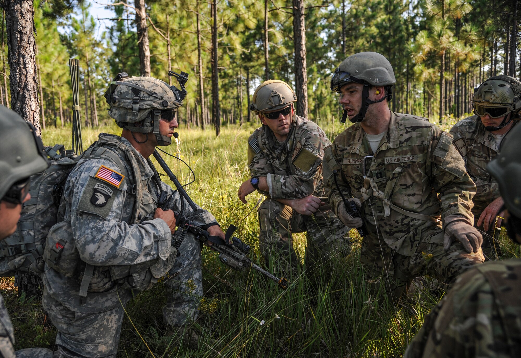 Capt. Michael Plummer (right), a 41st Airlift Squadron C-130J pilot, discusses an extraction plan for his team with a Soldier July 30, 2014 at Ft. Polk, La. Plummer and three loadmasters made up the first group of 19th Airlift Wing aircrew members to go through survival, evasion, resistance and escape training at the Joint Readiness Training Center. (U.S. Air Force photo by Airman 1st Class Harry Brexel)