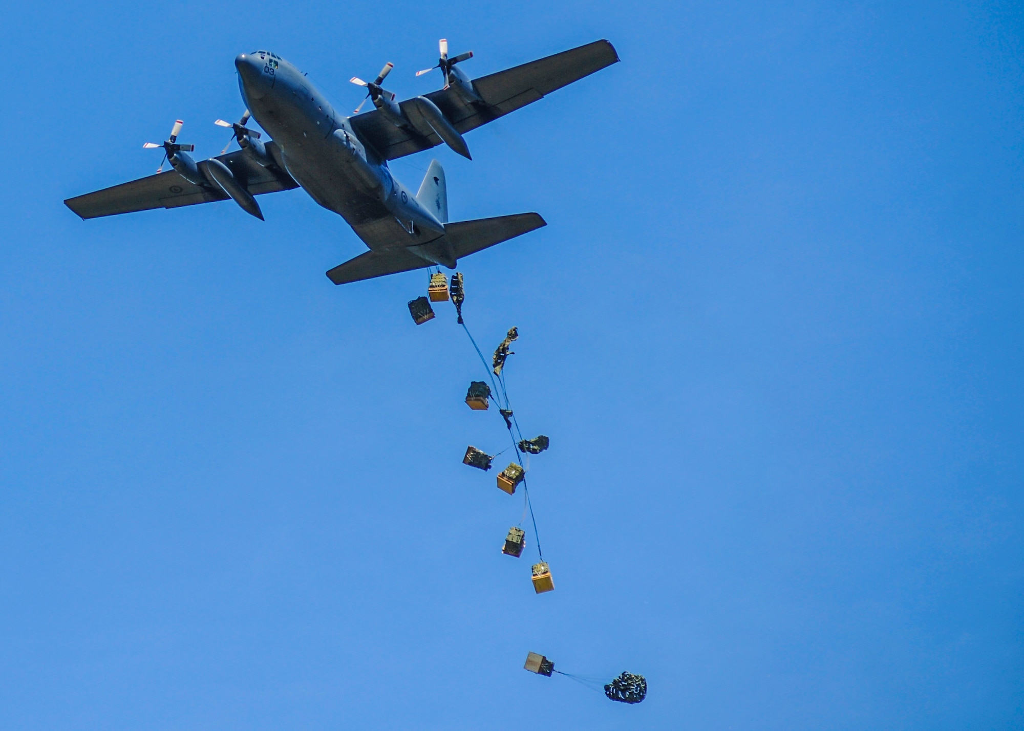 A Royal New Zealand Air Force C-130H drops cargo pallets as part of joint training July 30, 2014 at Ft. Polk, La. The 34th Combat Training Squadron often works with other branches and international partners to exercise and promote the importance of joint air mobility. (U.S. Air Force photo by Airman 1st Class Harry Brexel)
