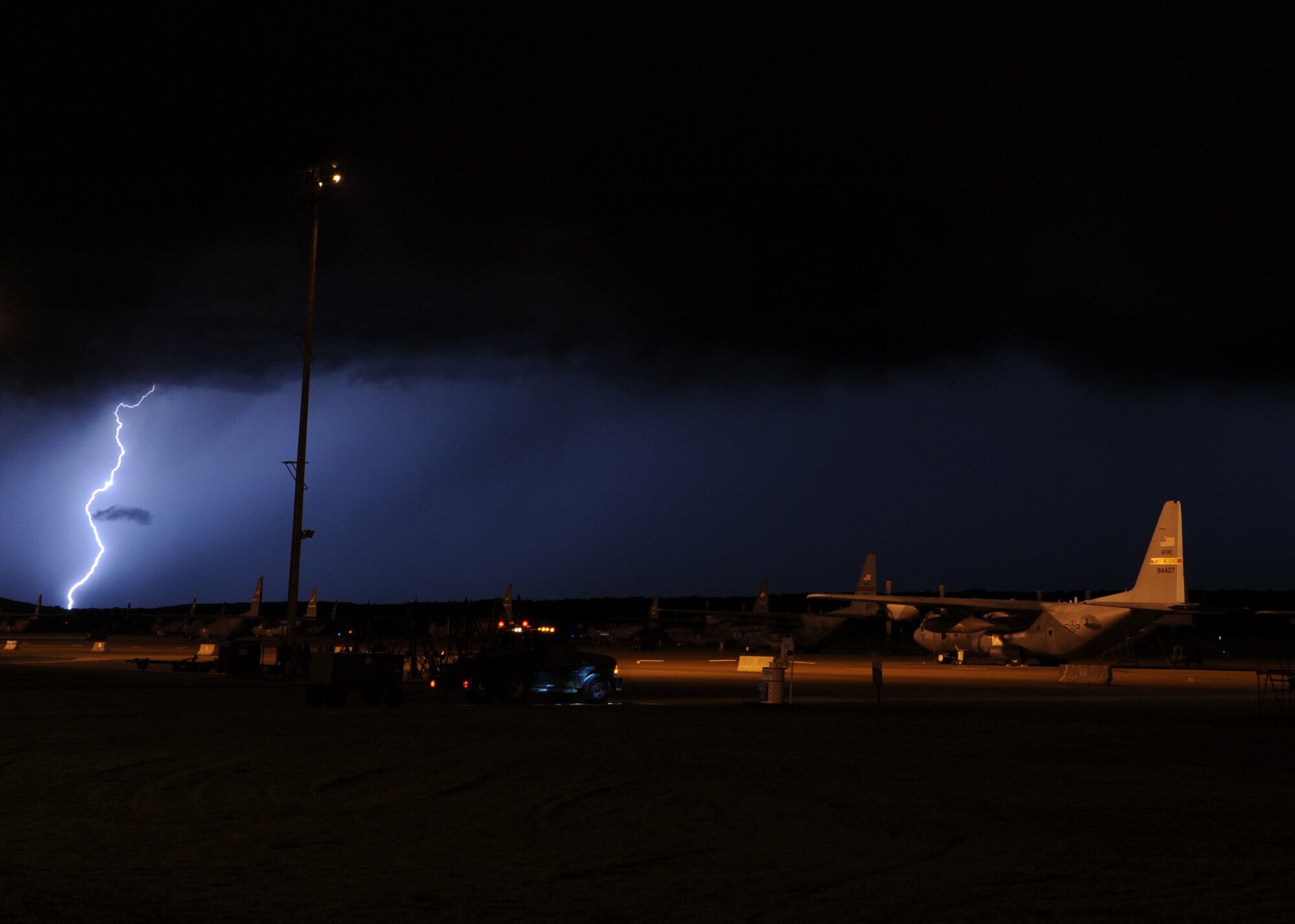 Lightning strikes as a storm approaches Little Rock Air Force Base, Ark., July 2, 2014. Arkansas weather can sometimes be relentless, dishing out stifling heat, tornadoes, floods, lightning, high winds and damaging hail during the summer months. (U.S. Air Force photo by Airman 1st Class Scott Poe) 