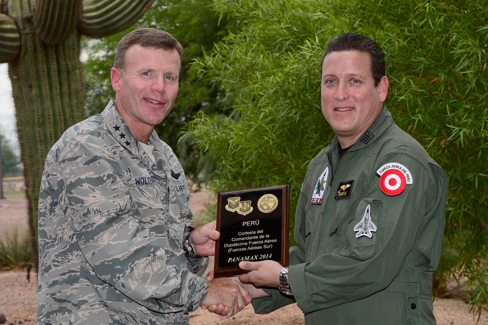 Lt. Gen. Tod Wolters, 12th Air Force (Air Forces Southern) commander, presents a PANAMAX 2014 participation plaque to Lt. Col. Antonio Garcia, Peru's senior officer participating in the exercise, during a recognition ceremony at Davis-Monthan AFB, Ariz., Aug. 14, 2014. Twenty-eight service members from six partner nations worked alongside their 12th AF (AFSOUTH) counterparts at Davis-Monthan during PANAMAX 2014. (U.S. Air Force photo by Tech. Sgt. Heather R. Redman/Released) 

