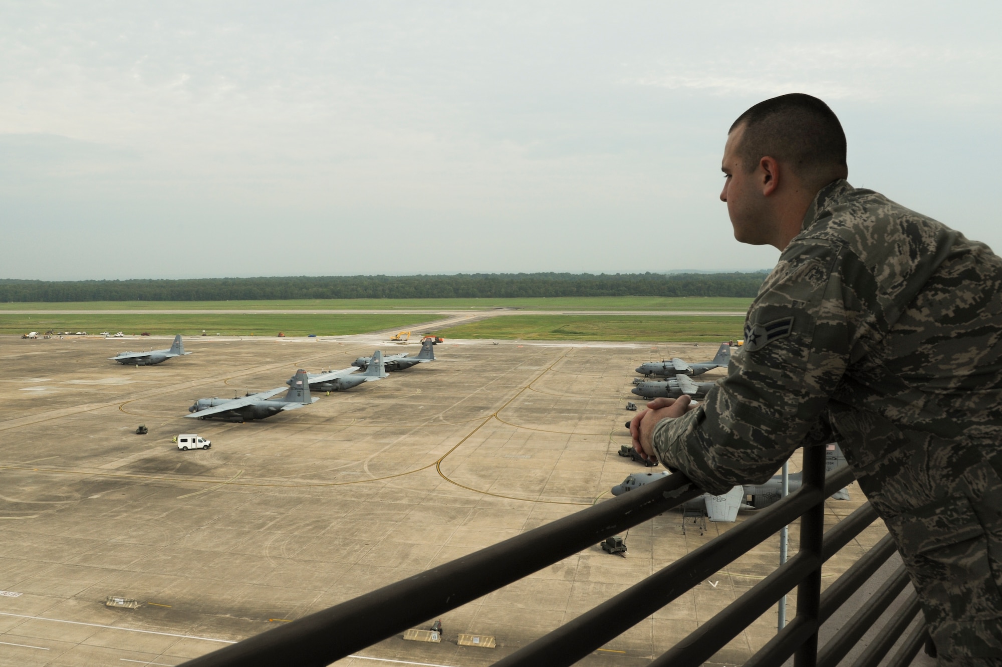 Airman 1st Class Travis Orndorff, a 19th Operations Support Squadron air traffic controller apprentice, looks over the flight line August 7, 2014, at Little Rock Air Force Base, Ark. The control tower is located near the flight line so the air traffic controllers can see plane movements. (U.S. Air Force photo by Airman 1st Class Mercedes Muro) 
