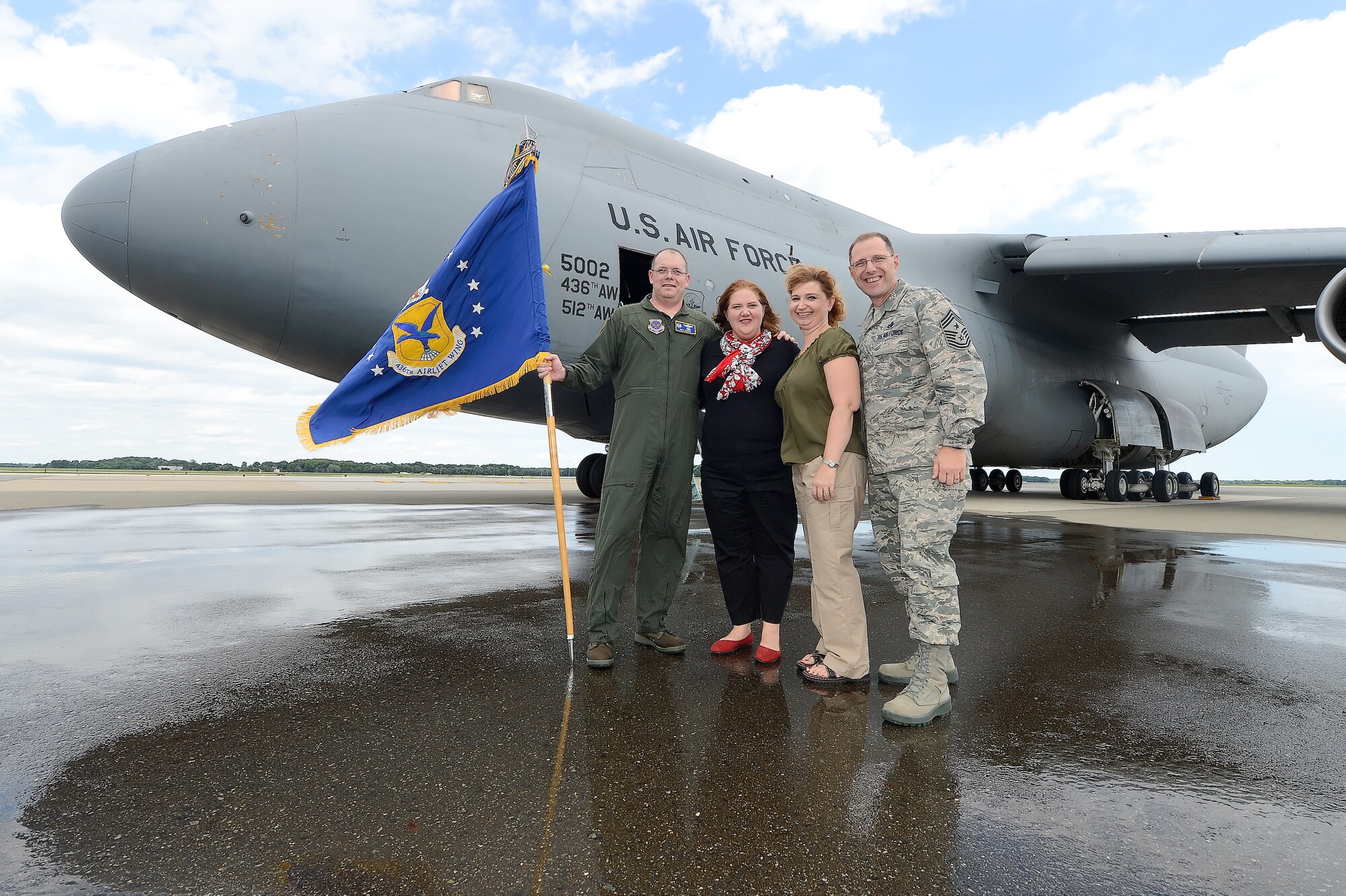 Col. Richard G. Moore, Jr., 436th Airlift Wing commander, and his wife Kristin, are joined by 436th AW Command Chief Master Sgt. Stanley Cadell and his wife Rhonda, after Moore completed his final flight as the leader of Team Dover on a C-5M Super Galaxy, 85-0002, on Aug. 14, 2014, at Dover Air Force Base, Del. (U.S. Air Force photo/Greg L. Davis)