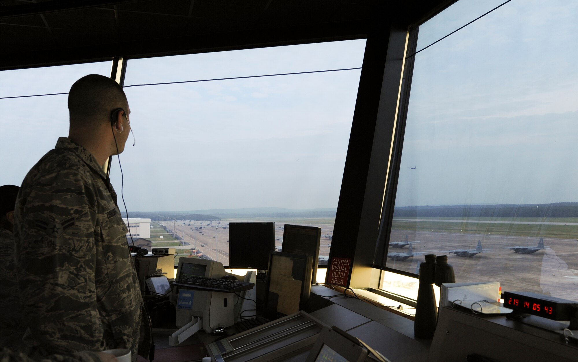 Airman 1st Class Travis Orndorff, a 19th Operations Support Squadron air traffic controller apprentice, watches a plane take off from the flight line August 7, 2014, Little Rock Air Force Base, Ark. Orndorff and other air traffic controllers communicate with aircraft to coordinate their movements. (U.S. Air Force photo by Airman 1st Class Mercedes Muro)