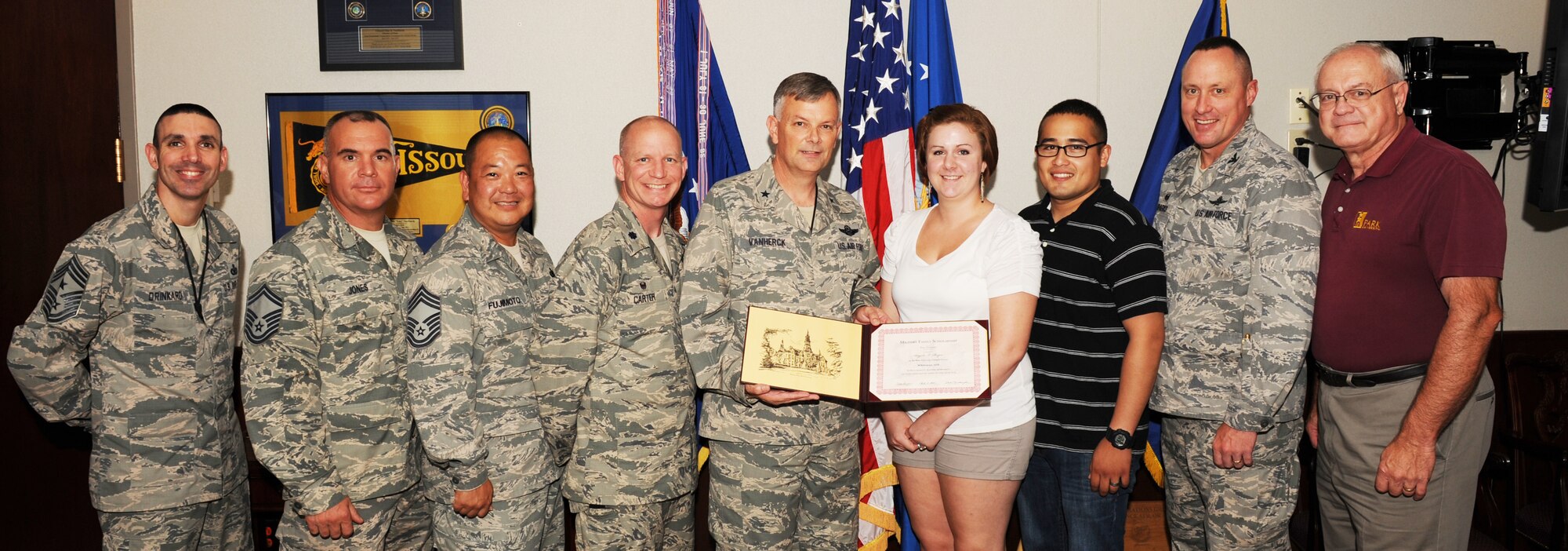 Angela Reyes, spouse of Airman 1st Class Juan Reyes, receives a scholarship from Park University at Whiteman Air Force Base, Missouri, Aug. 8, 2014. The scholarship is for a total of 15 semester hours to be used in the upcoming academic year and can be taken at three semester hours per term. The value of the scholarship is in excess of $4,000 (U.S. Air Force photo by Airman 1st Class Keenan Berry/Released)