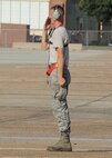 Senior Airman Mitchell Dexter, 2nd Aircraft Maintenance Squadron crew chief, renders a salute to a B-52H Stratofortress aircrew preparing to launch during a Minimum Interval Takeoff on Barksdale Air Force Base, La., Aug. 14, 2014. The small launch window of a MITO, combined with turbulence created by preceeding aircraft that can create rough air for the following aircraft, gives aircrew an opportunity to demonstrate their skills and abilities. (U.S. Air Force photo/Staff Sgt. Sean Martin)