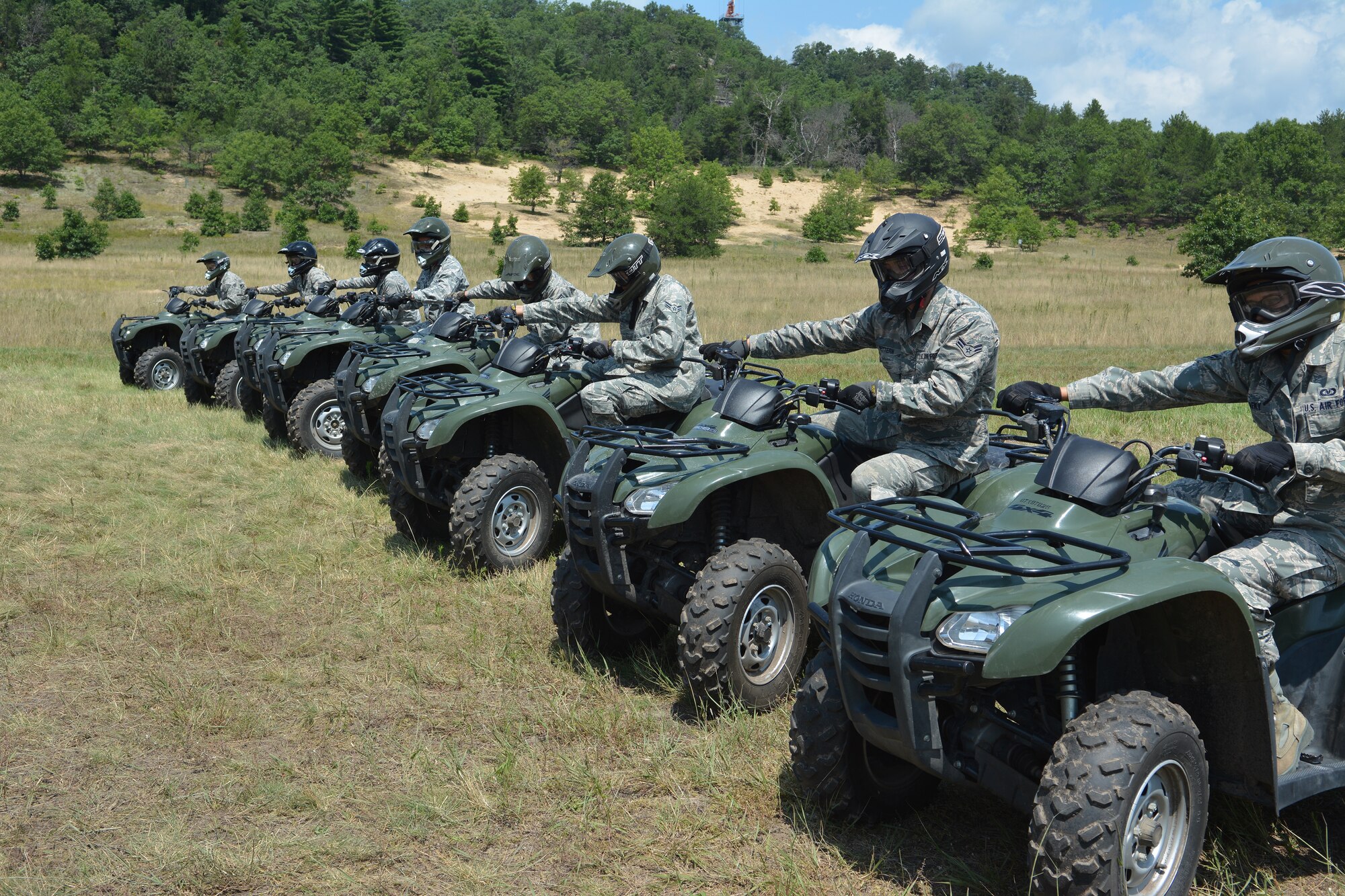 Airmen from Wisconsin prepare for their all-terrain vehicle ride after completing the first few lessons of the ATV certification course at Volk Field Air National Guard Base, Wis., July 30, 2014. The Airmen completed the course as part of the Junior Enlisted opportunity Program. They spent three days touring the 115th Fighter Wing, Volk Field and the 128th Air Refueling Wing to gain a better understanding of each bases’ mission. (Photo courtesy of Master Sgt. Sara Jensen)
