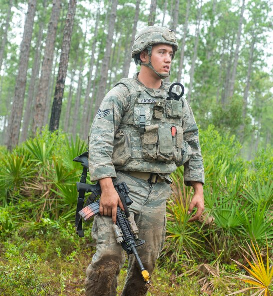 U.S. Air Force Senior Airman Derrick Harris, 823d Base Defense Squadron fire team leader, scans the area for possible threats during exercise Safeside Guardian at Camp Blanding, Fla., Aug. 12, 2014. McKee’s area of responsibility was attacked by a simulated mortar, and he was evaluated on how he responded. (U.S. Air Force photo by Airman 1st Class Ceaira Tinsley/Released)