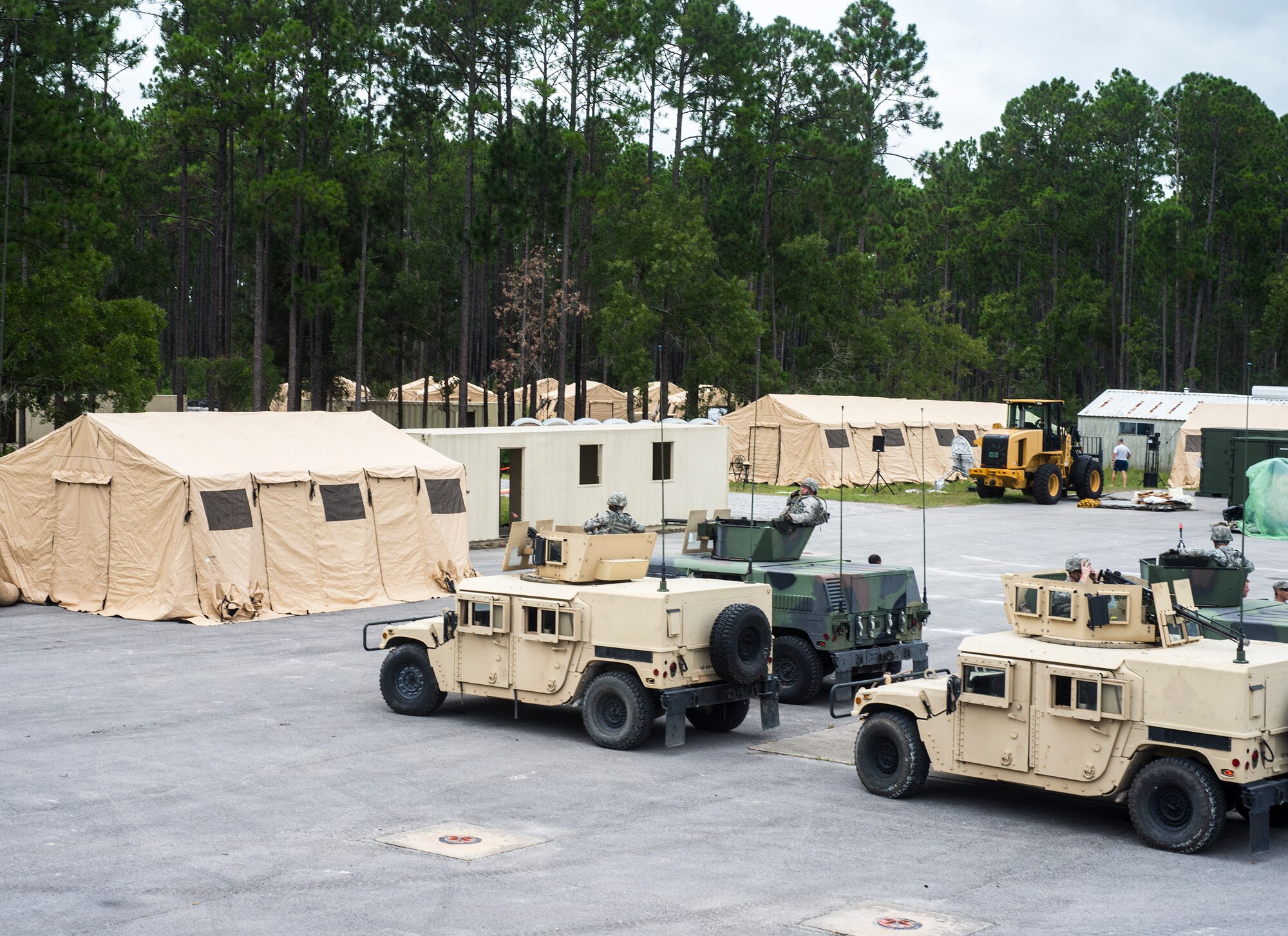 A convoy of Airmen in Humvees prepares to leave for a patrol to familiarize themselves with the area during exercise Safeside Guardian at Camp Blanding, Fla., Aug. 12, 2014. While deployed, the 823d Base Defense Squadron convoys patrol eight-10 hours a day to establish their presence in the area. (U.S. Air Force photo by Airman 1st Class Ceaira Tinsley/Released)
