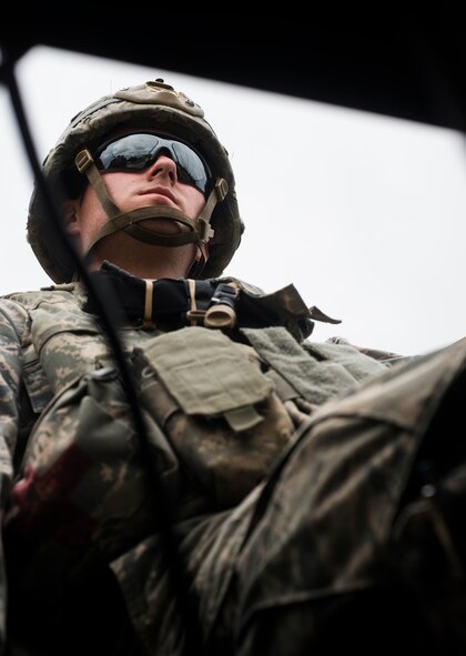 U.S. Air Force Senior Airman Nicholas McKeehan, 823d Base Defense Squadron dismount driver, scans the area during Safeside Guardian at Camp Blanding, Fla., Aug. 12, 2014. McKeehan manned a .50 caliber M2 machine gun, providing rear security during the simulated exercise.  (U.S. Air Force photo by Airman 1st Class Ceaira Tinsley/Released)