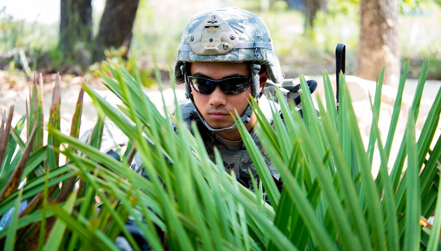 U.S. Air Force Senior Airman Matthew Phoodej, 823d Base Defense Squadron fire team member, provides security as the first line of defense against an attack during exercise Safeside Guardian at Camp Blanding, Fla., Aug. 12, 2014. Phoodej dug a hole and secured it with sand bags to provide concealment and cover in case of an attack. (U.S. Air Force photo by Airman 1st Class Ceaira Tinsley/Released)