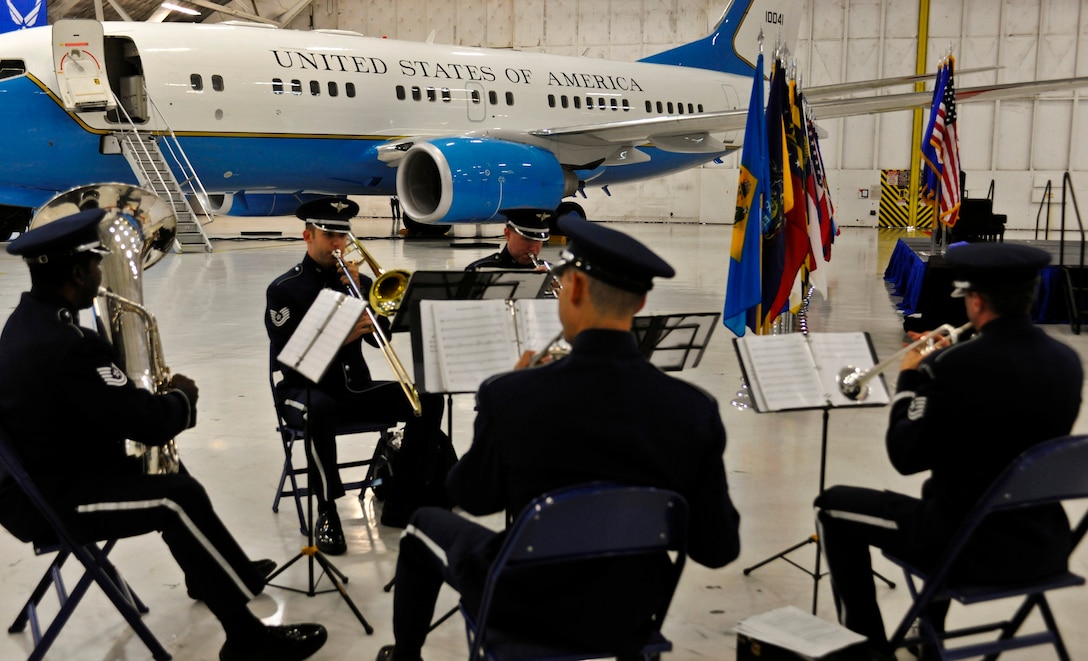 The U.S. Air Force Band Ceremonial Brass Quintet performs “Four Cohan Songs” as Airmen from the 89th Airlift Wing, 11th Wing and other guests file into the 89th AW change-of-command ceremony at Joint Base Andrews, Md., Aug. 14, 2014. Col. John C. Millard assumed command of the 89th, known as the Special Air Mission (Foreign) team, or simply SAM Fox, after serving as the commander of the 376th Expeditionary Wing, Transit Center Manas, Kyrgyz Republic. (U.S. Air Force photo by Master Sgt. Kevin Wallace/RELEASED)